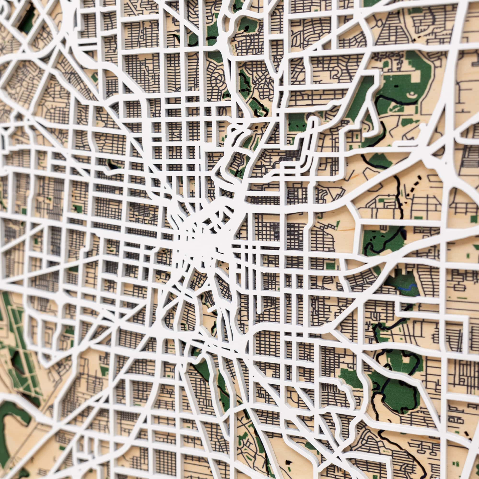 Framed map of San Antonio with decorative pins on a white surface.