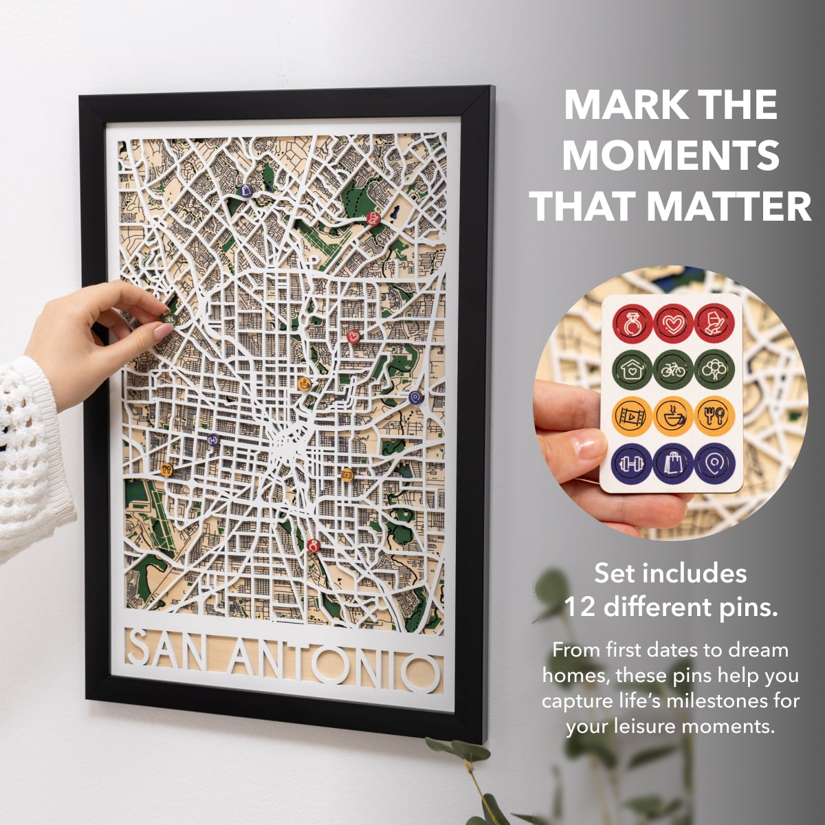 Framed map of San Antonio with decorative pins on a white surface.
