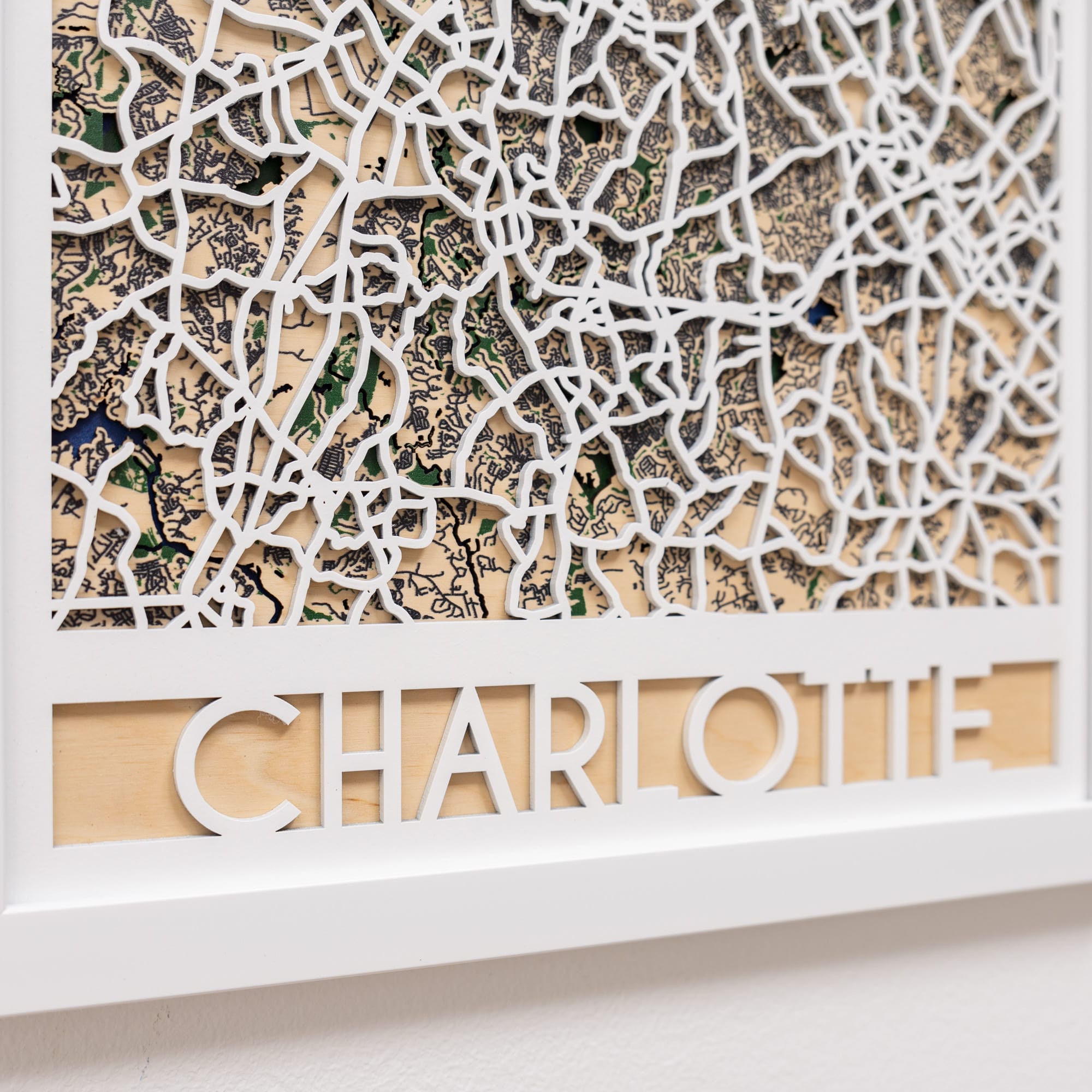 Decorative wall panel with intricate cut-out design and 'Charlotte' text