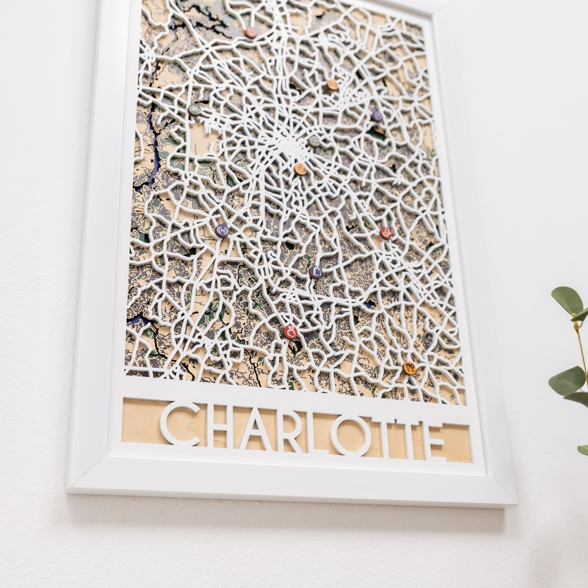 Decorative wall art with a textured design and 'Charlotte' text on a white background