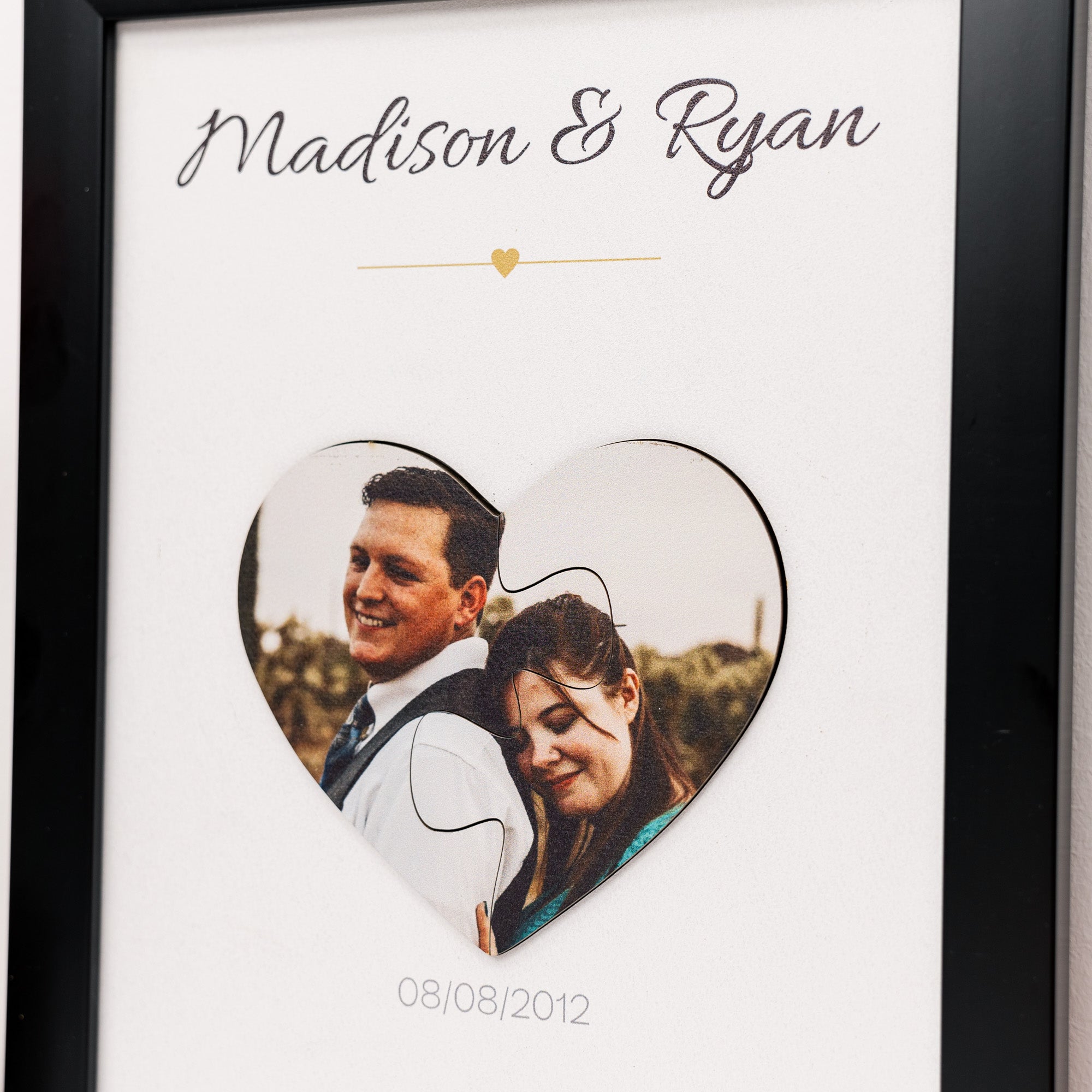 Heart-shaped photo frame with a couple's picture and 'Madison & Ryan' text