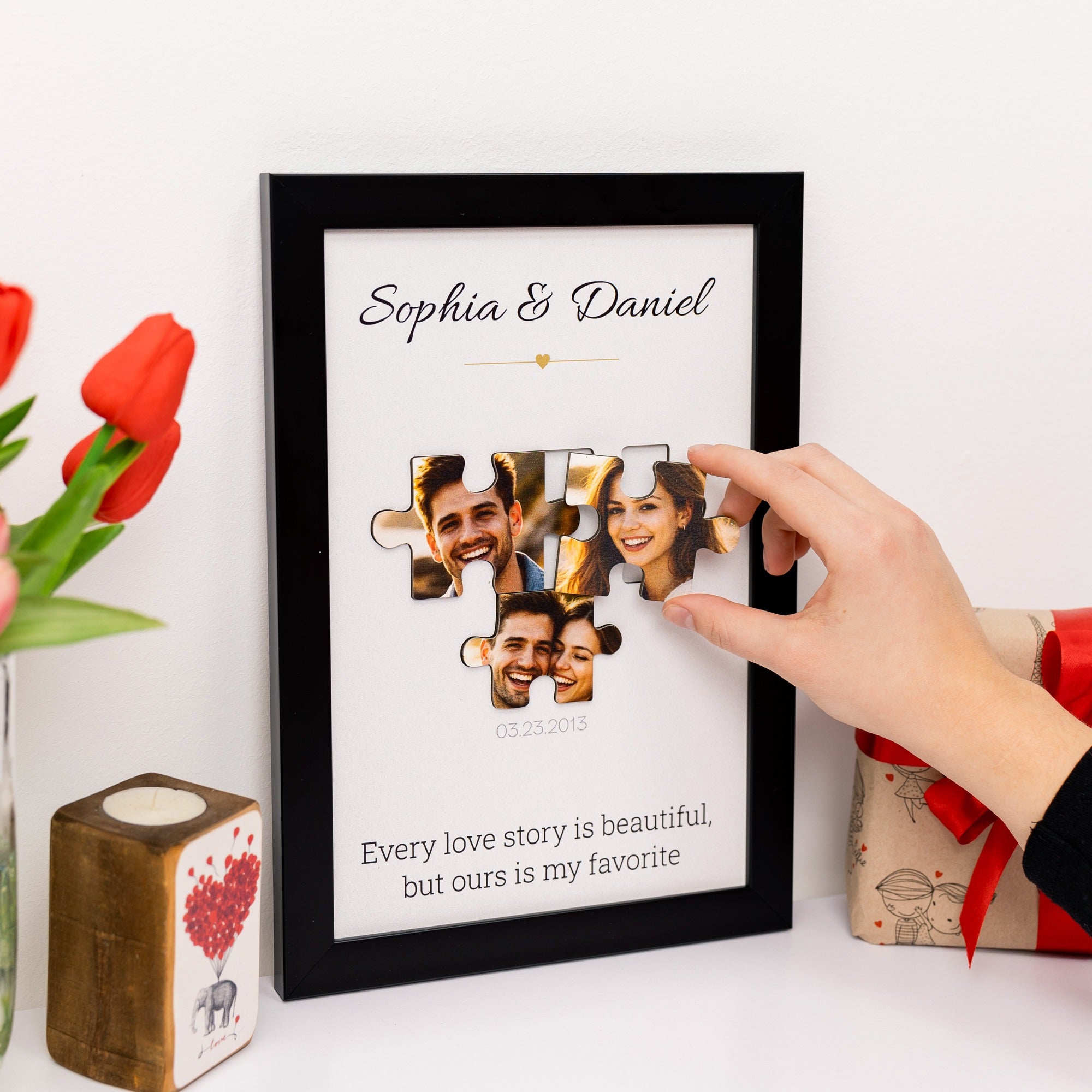 Personalized photo frame with puzzle piece design, featuring a couple's faces, on a white surface with decorative items.