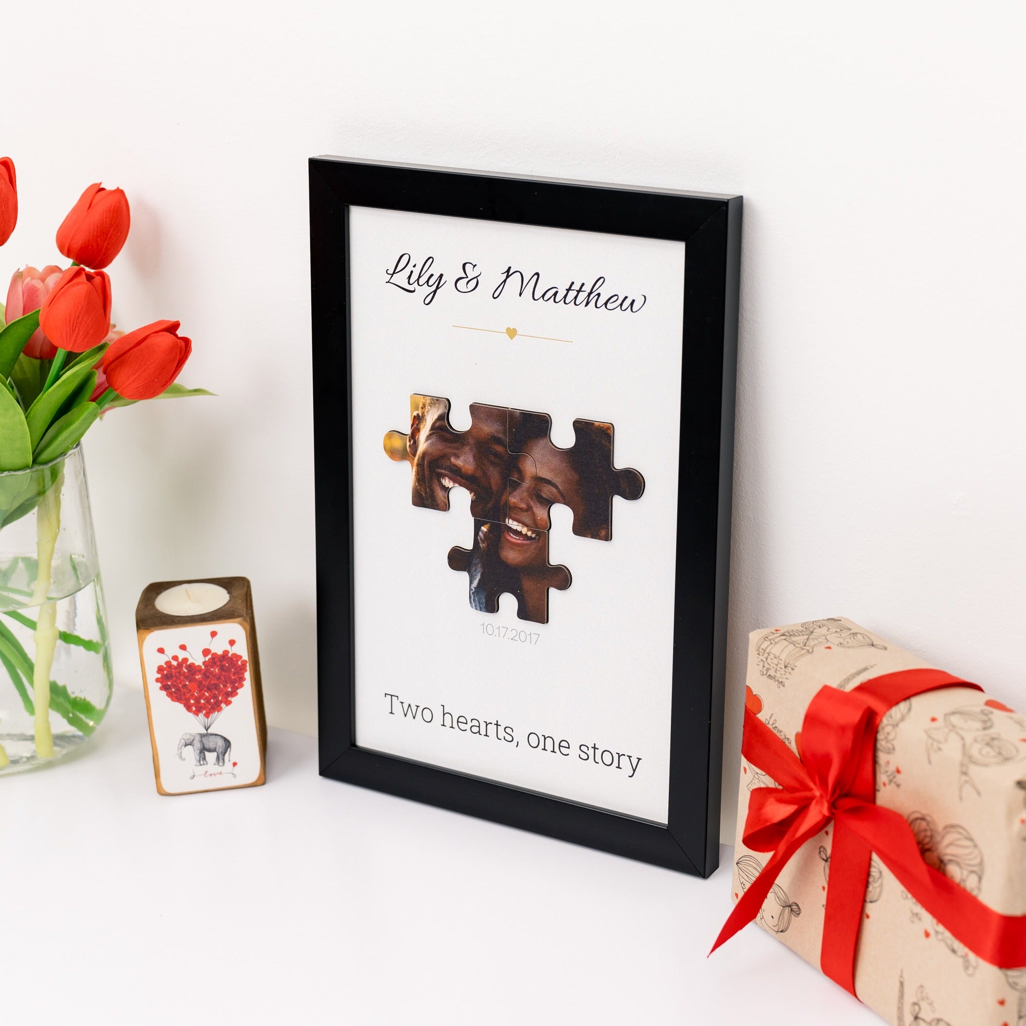 Framed puzzle piece photo with 'Lily & Matthew' text, surrounded by flowers and a gift box.