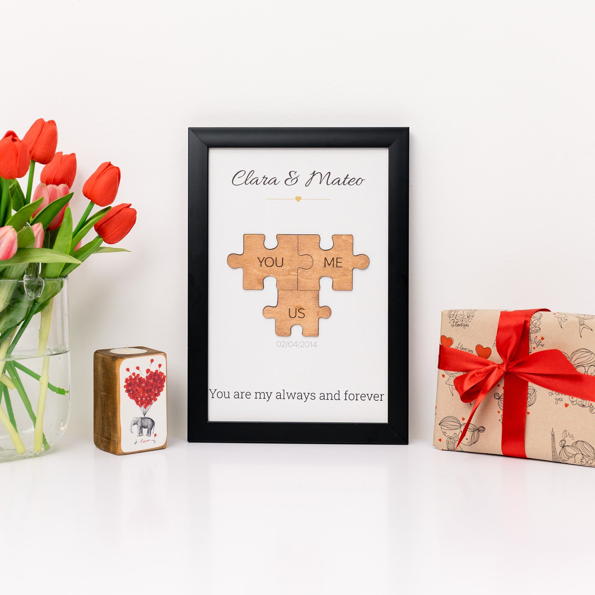 Framed puzzle piece art with 'Clara & Mateo' and decorative items on a white surface