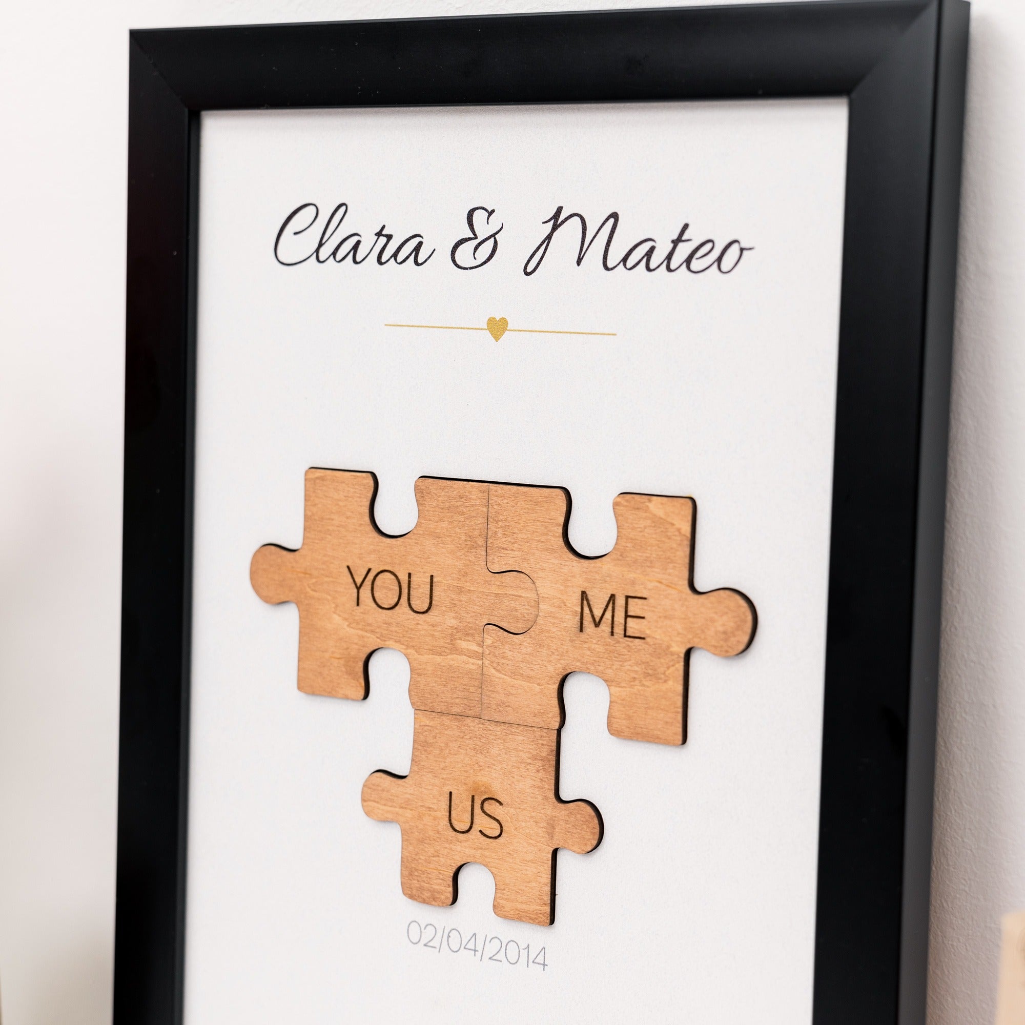 Framed wooden puzzle pieces with 'You', 'Me', and 'Us' text on a white background