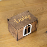 A small wooden house-shaped box