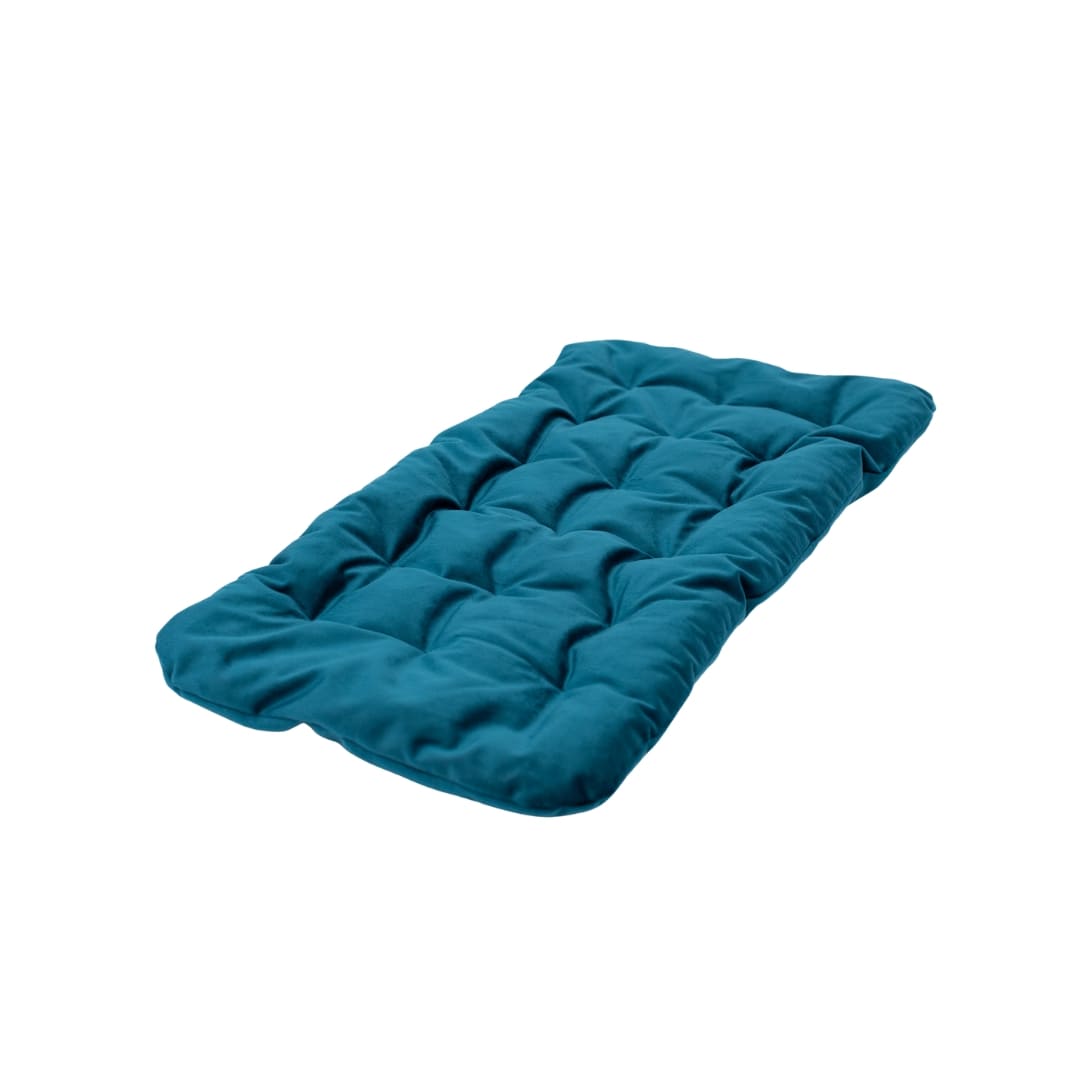 Teal quilted cover on a white surface