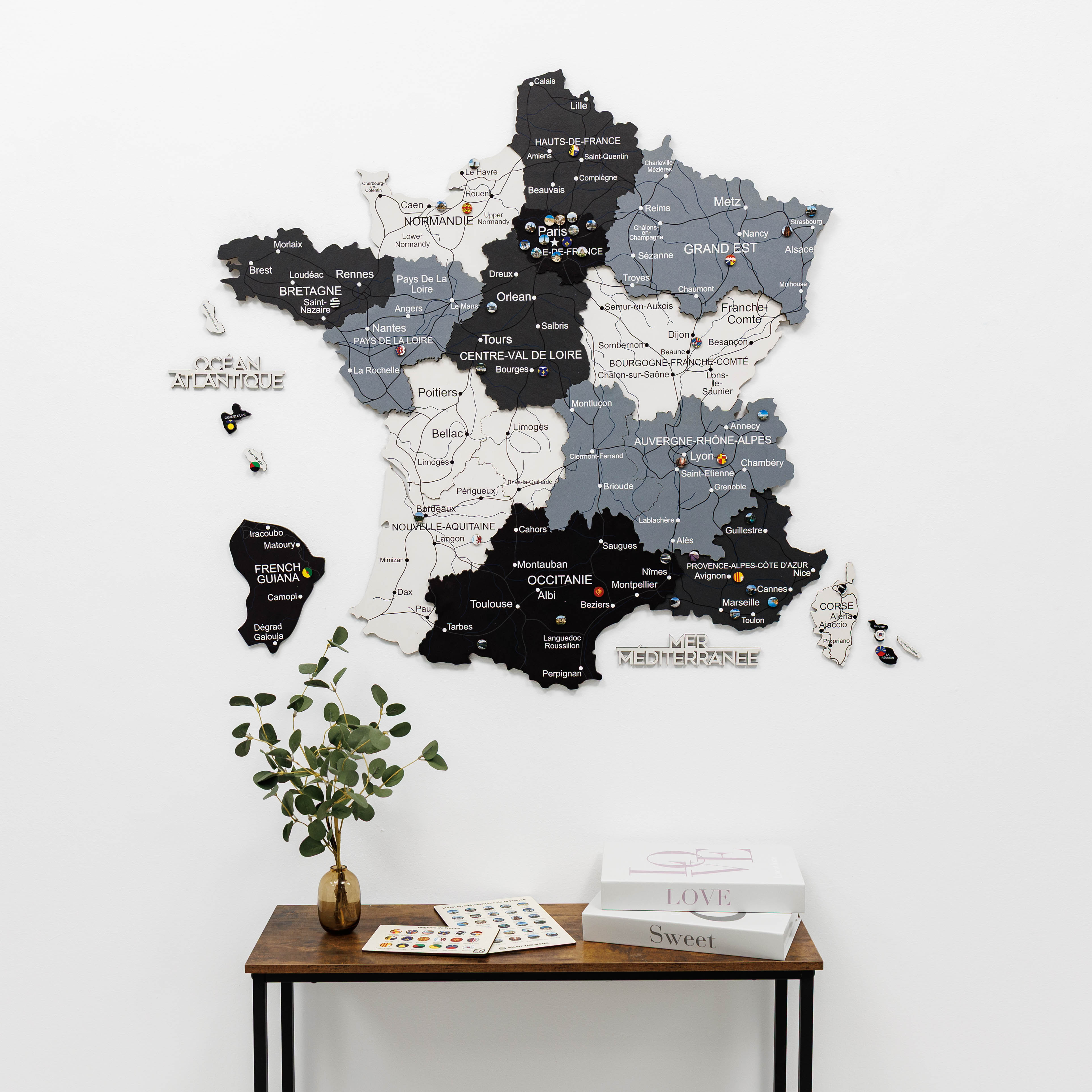 Woman interacting with a wall-mounted map of France