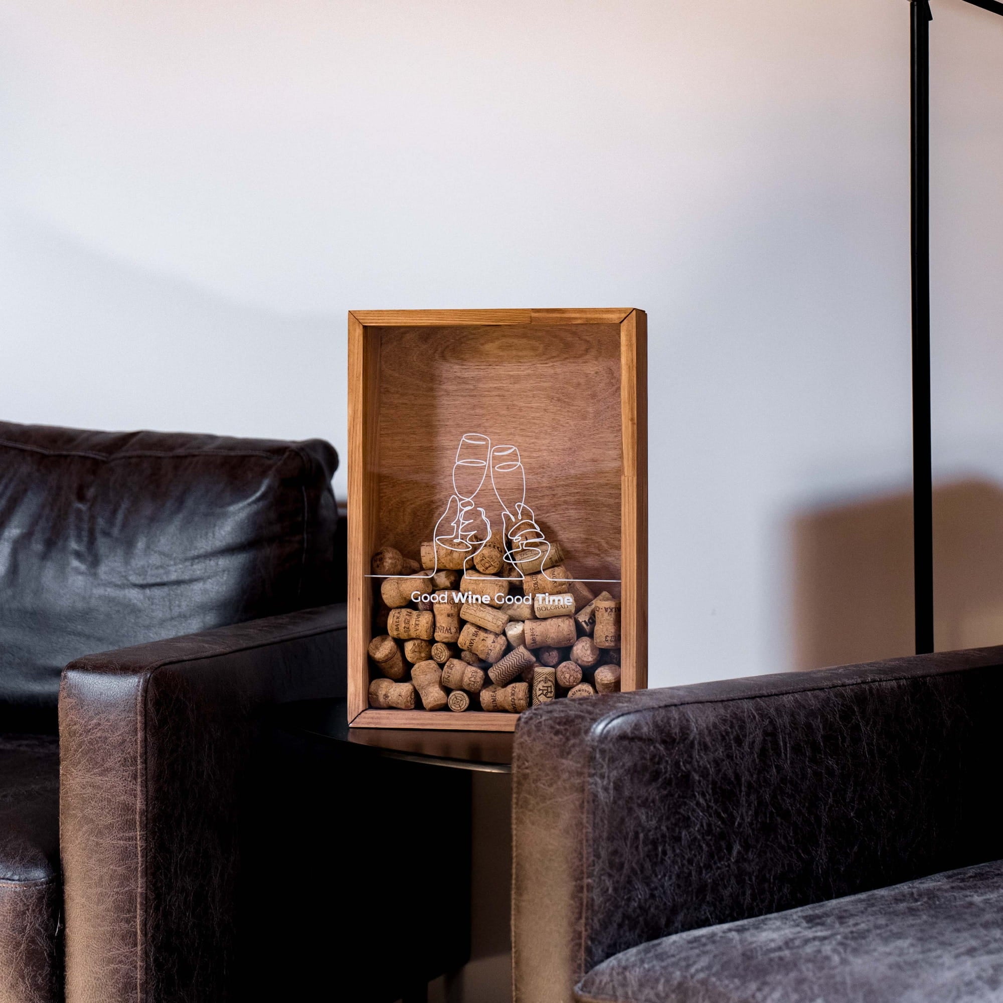 A rectangular wooden display box filled with wine corks