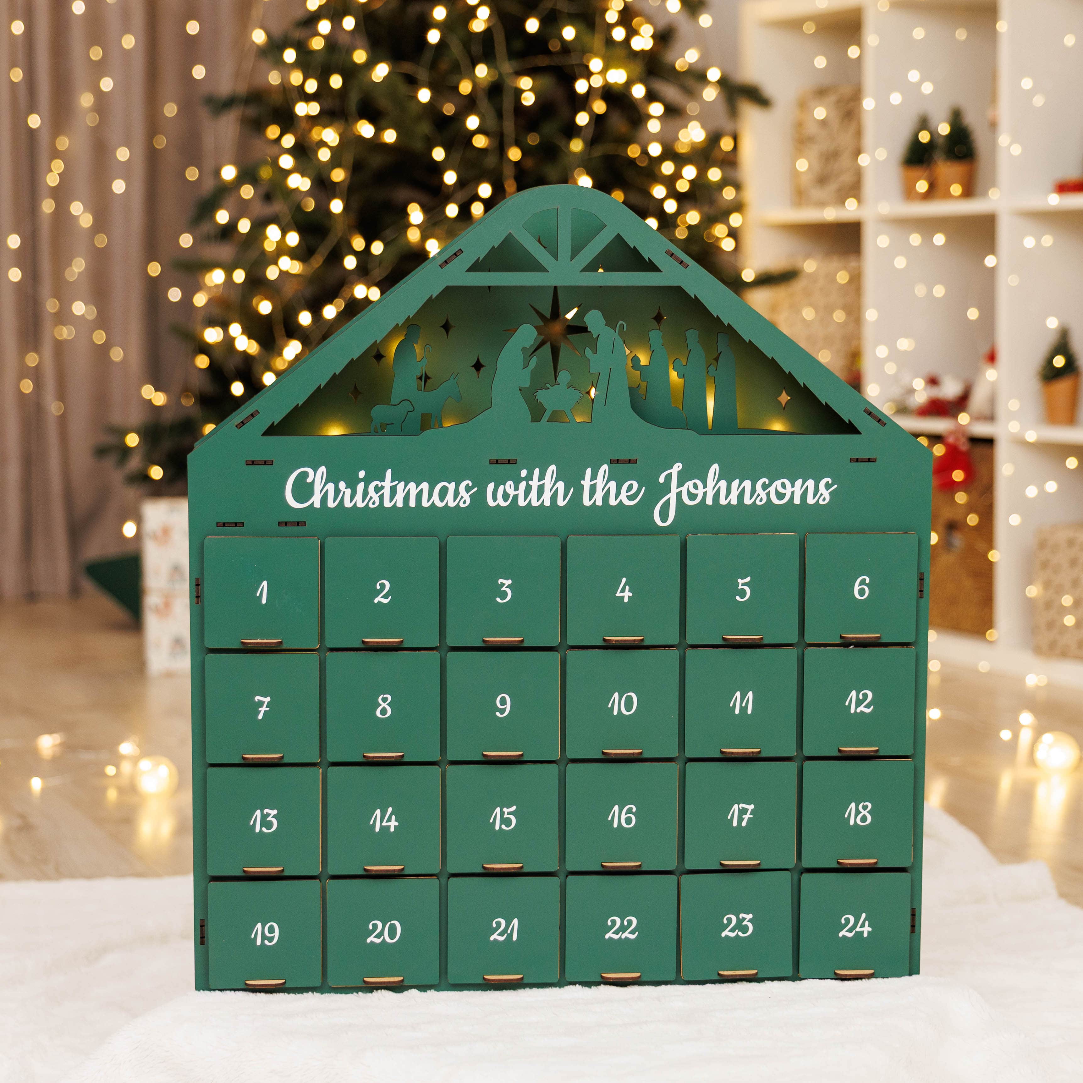 Green advent calendar with 'Christmas with the Johnsons' text in a festive setting with a Christmas tree.