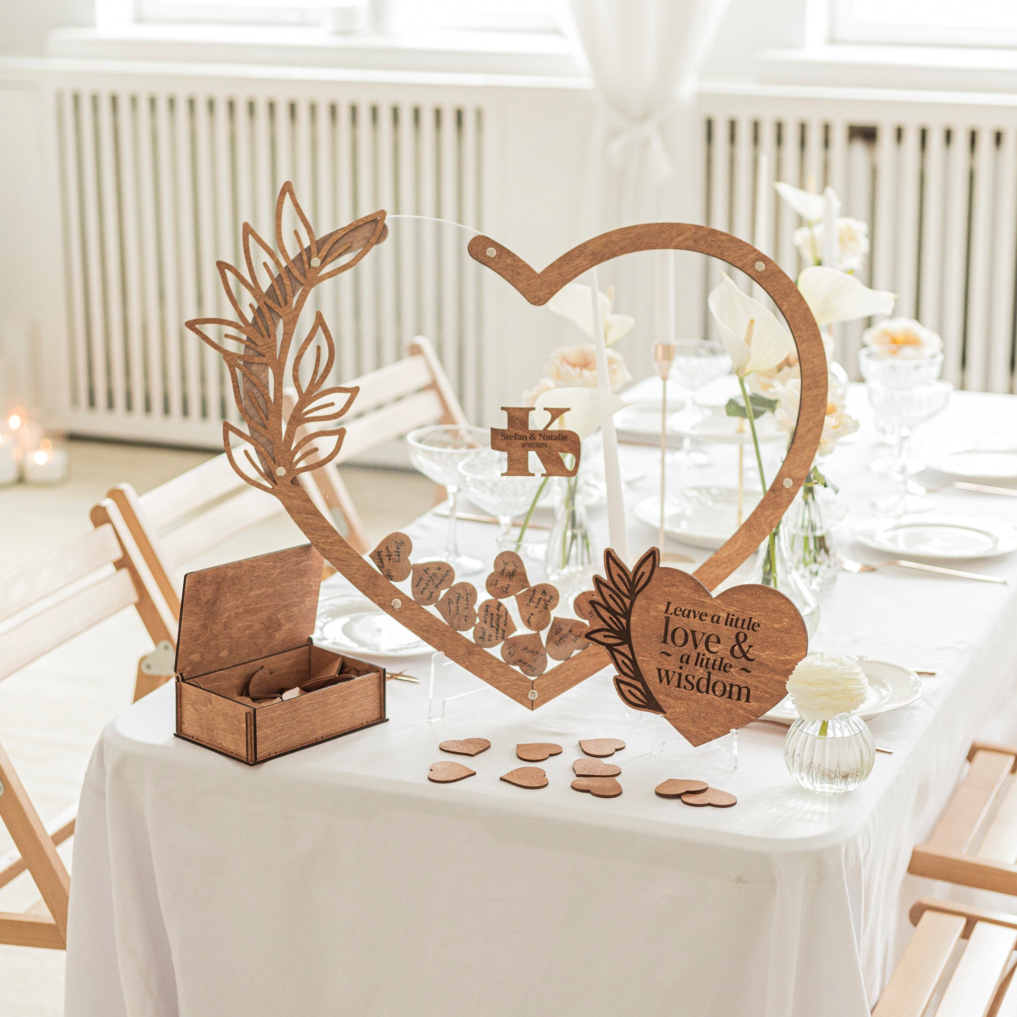 Wooden heart-shaped decorative item with cut-out designs on a table setting.