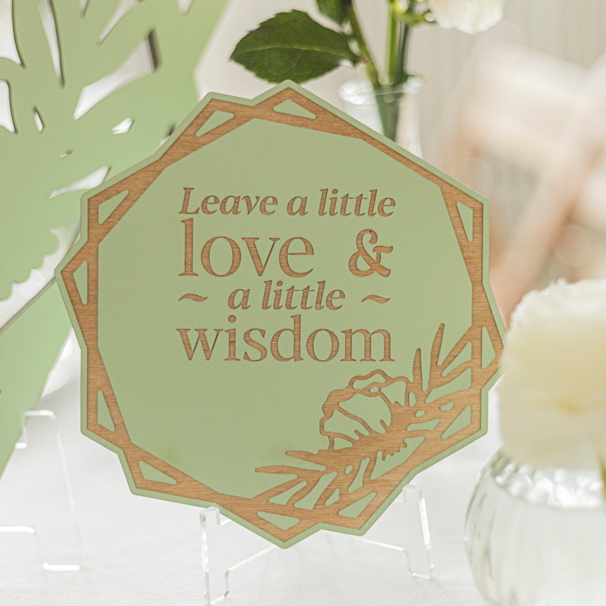 Decorative card with 'Leave a little love & a little wisdom' text on a light green background.