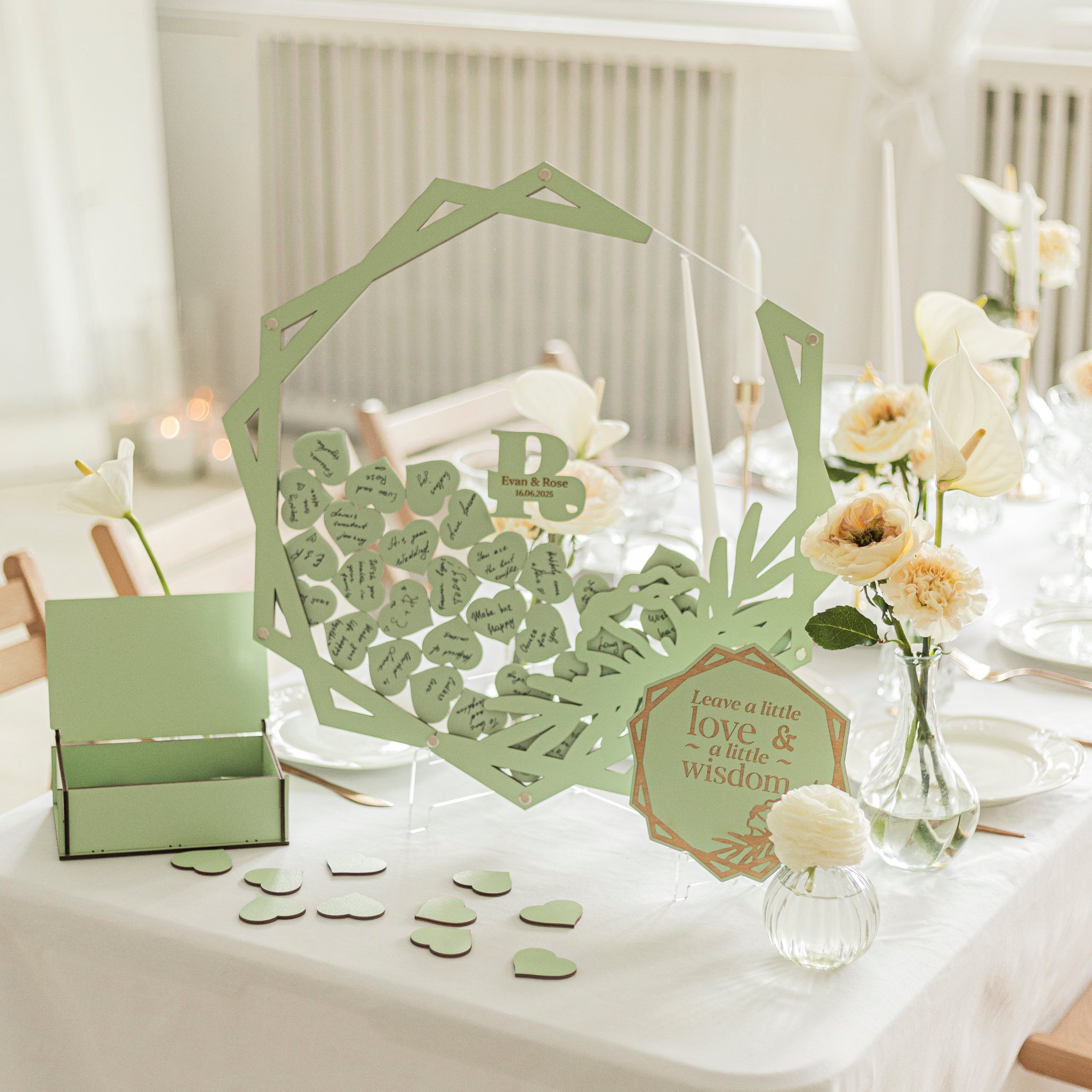 Decorative table setting with green letter cutouts and floral arrangements.
