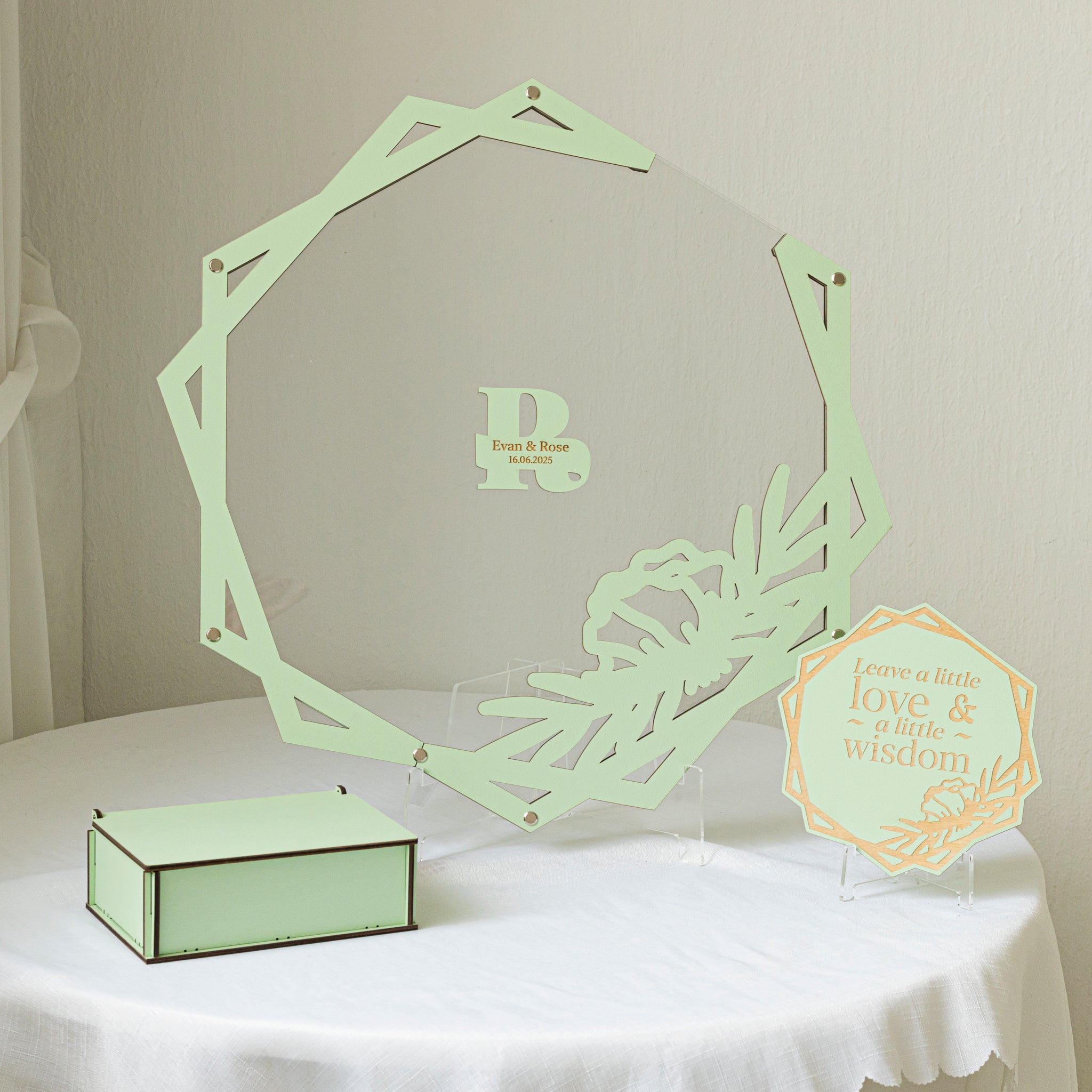 Decorative green laser-cut acrylic piece on a white tablecloth with a neutral background