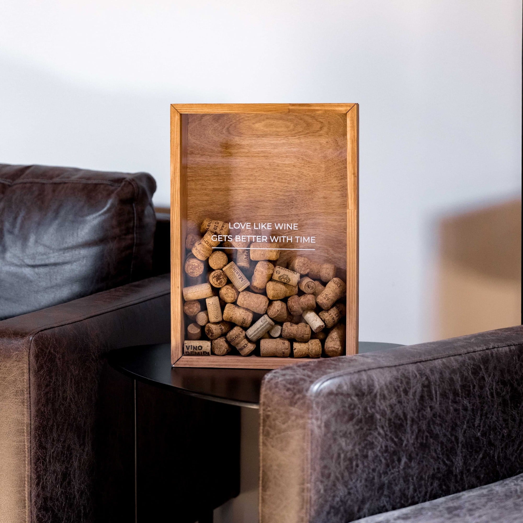 A rectangular wooden wine cork display box with a clear front panel 