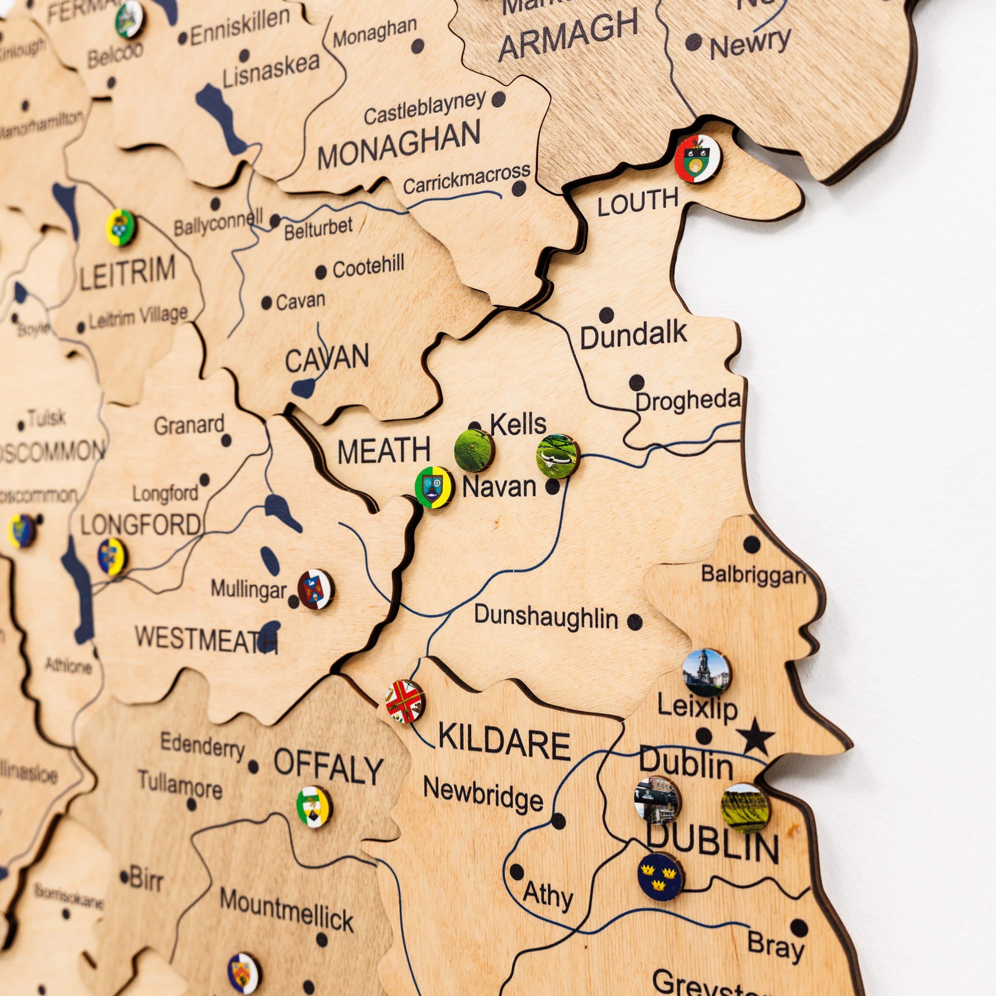 Wooden map of Ireland with various locations marked by pins.
