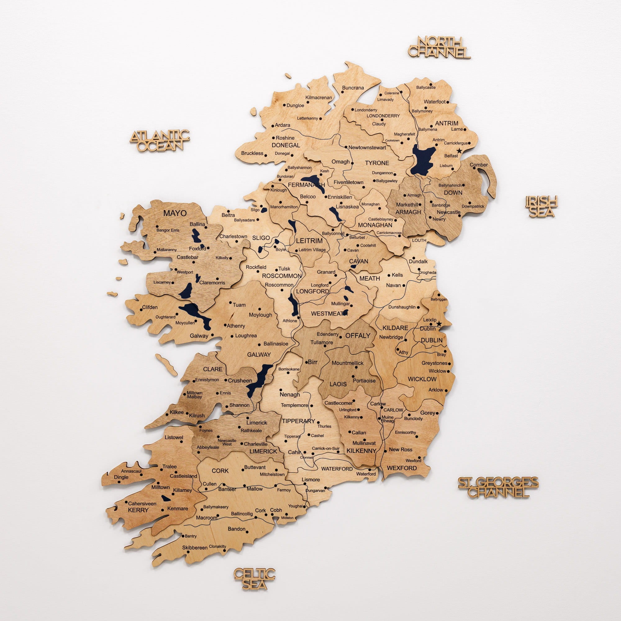 Wooden map of Ireland with counties labeled on a white background