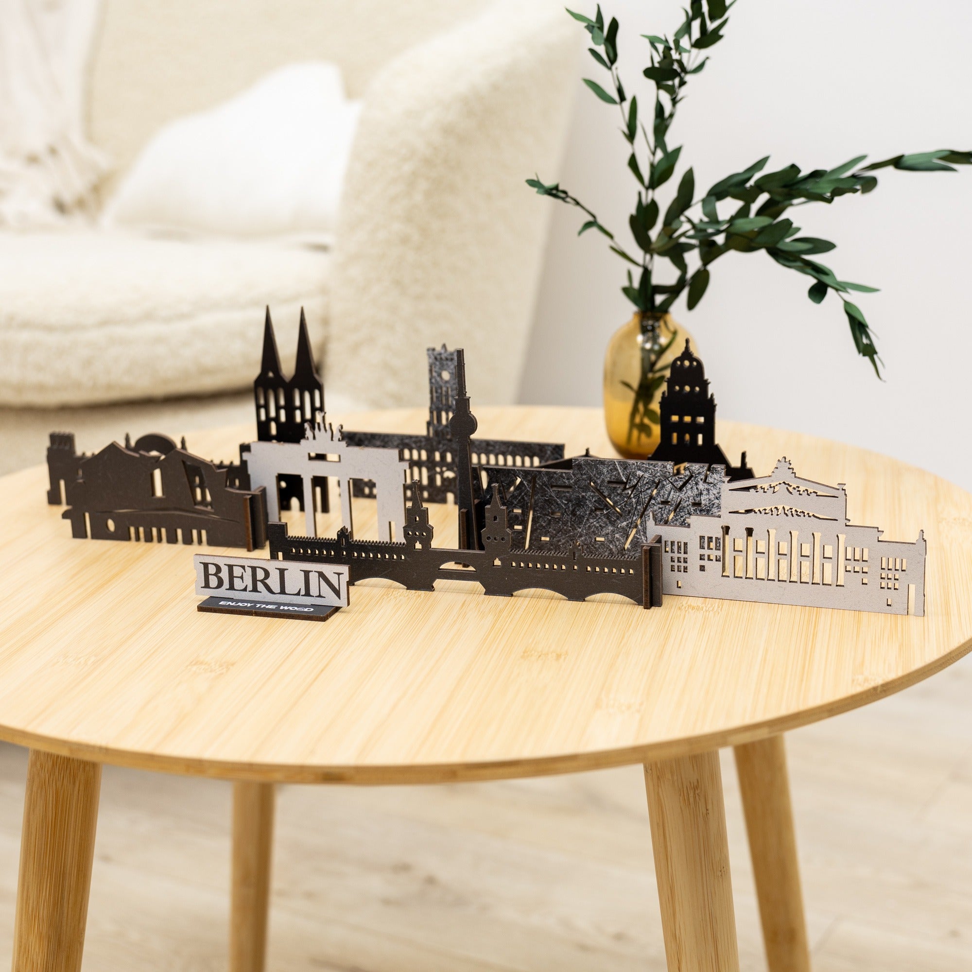 Model of Berlin skyline on a wooden table with a plant in the background
