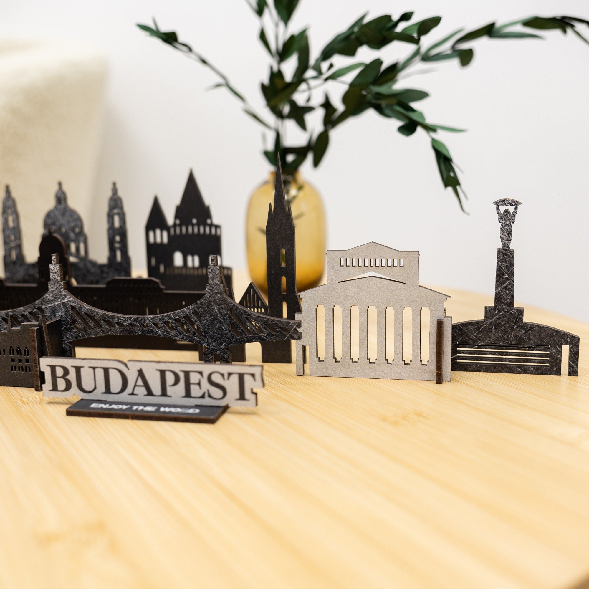Model of Budapest landmarks on a wooden surface with a blurred plant in the background