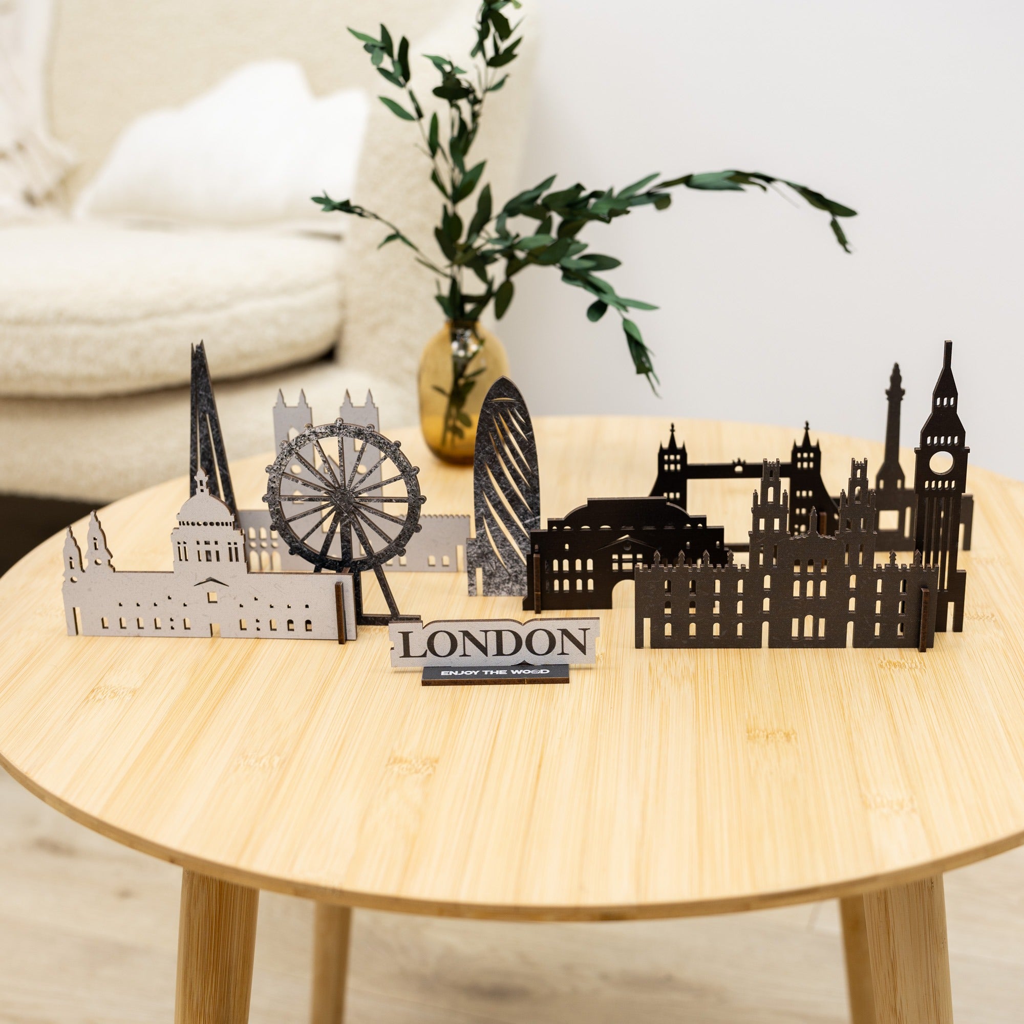 Model of London skyline on a wooden table with a plant in the background