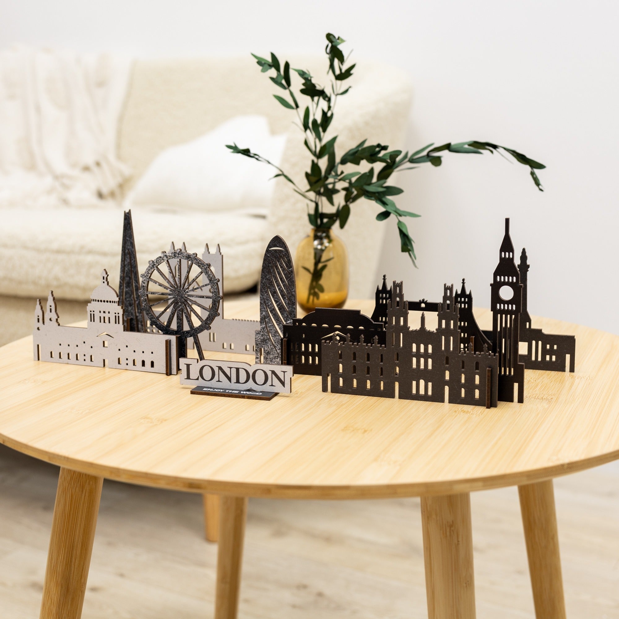 Model of London skyline on a wooden table with a plant in the background