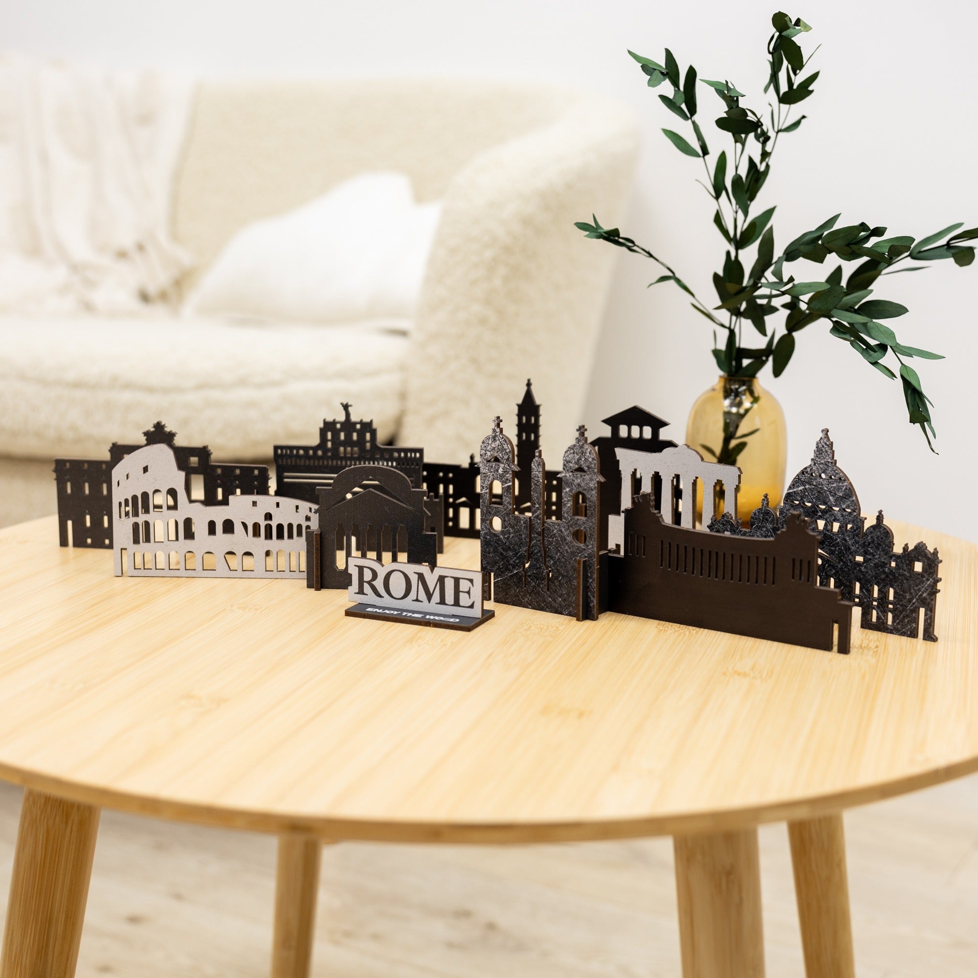Model of Rome on a wooden table with a plant in the background