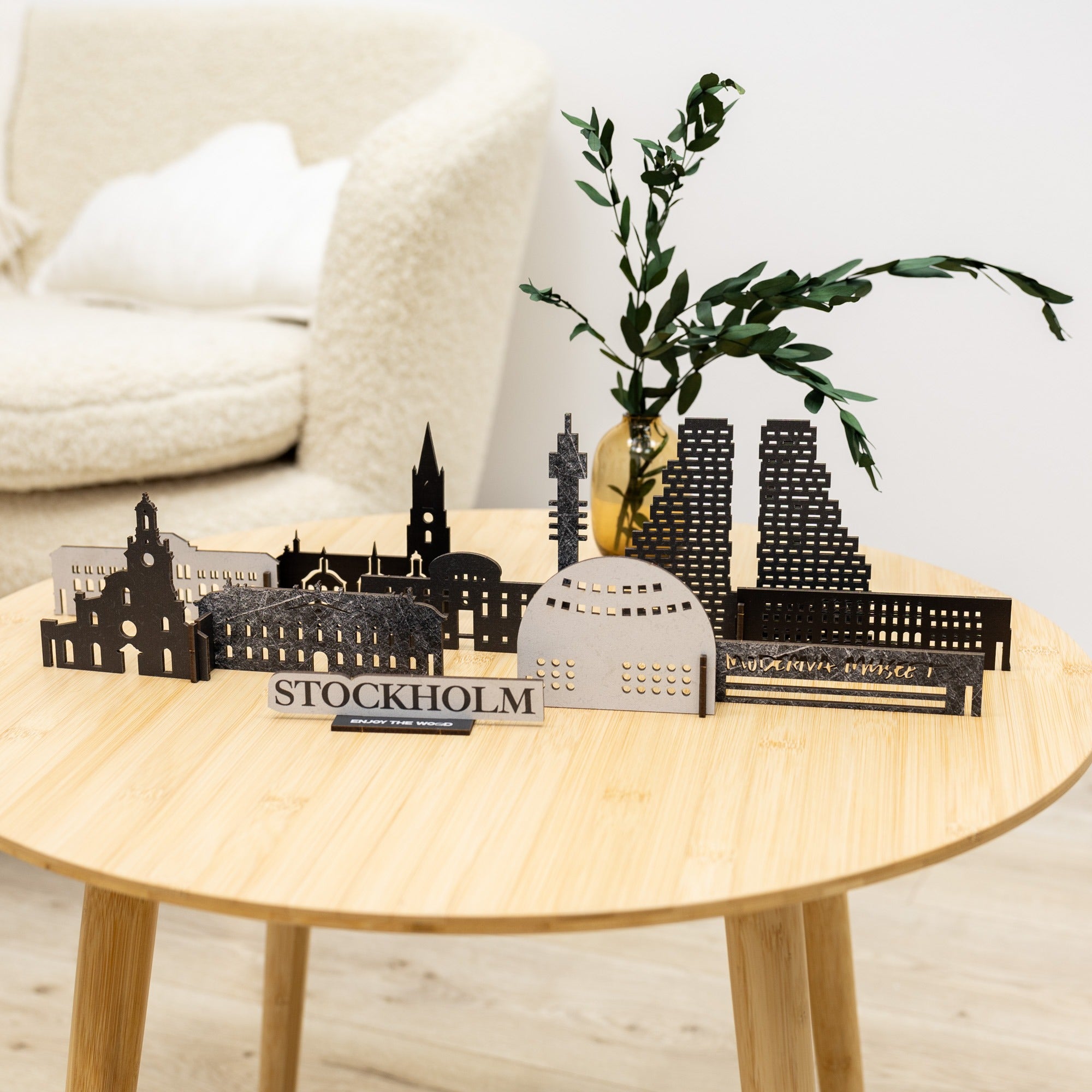 Model of Stockholm skyline on a wooden table with a plant in the background