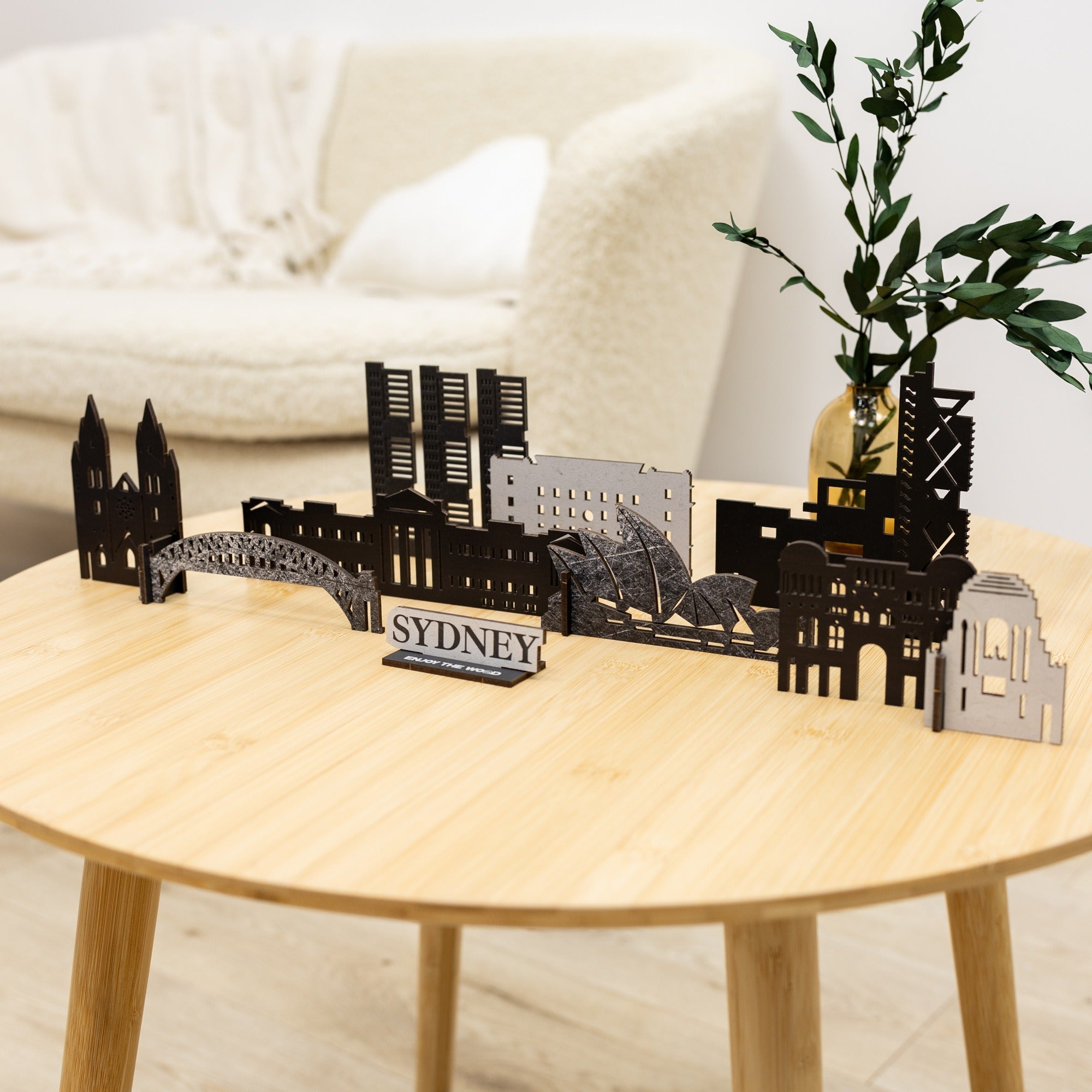 Model of Sydney skyline on a wooden table with a plant in the background