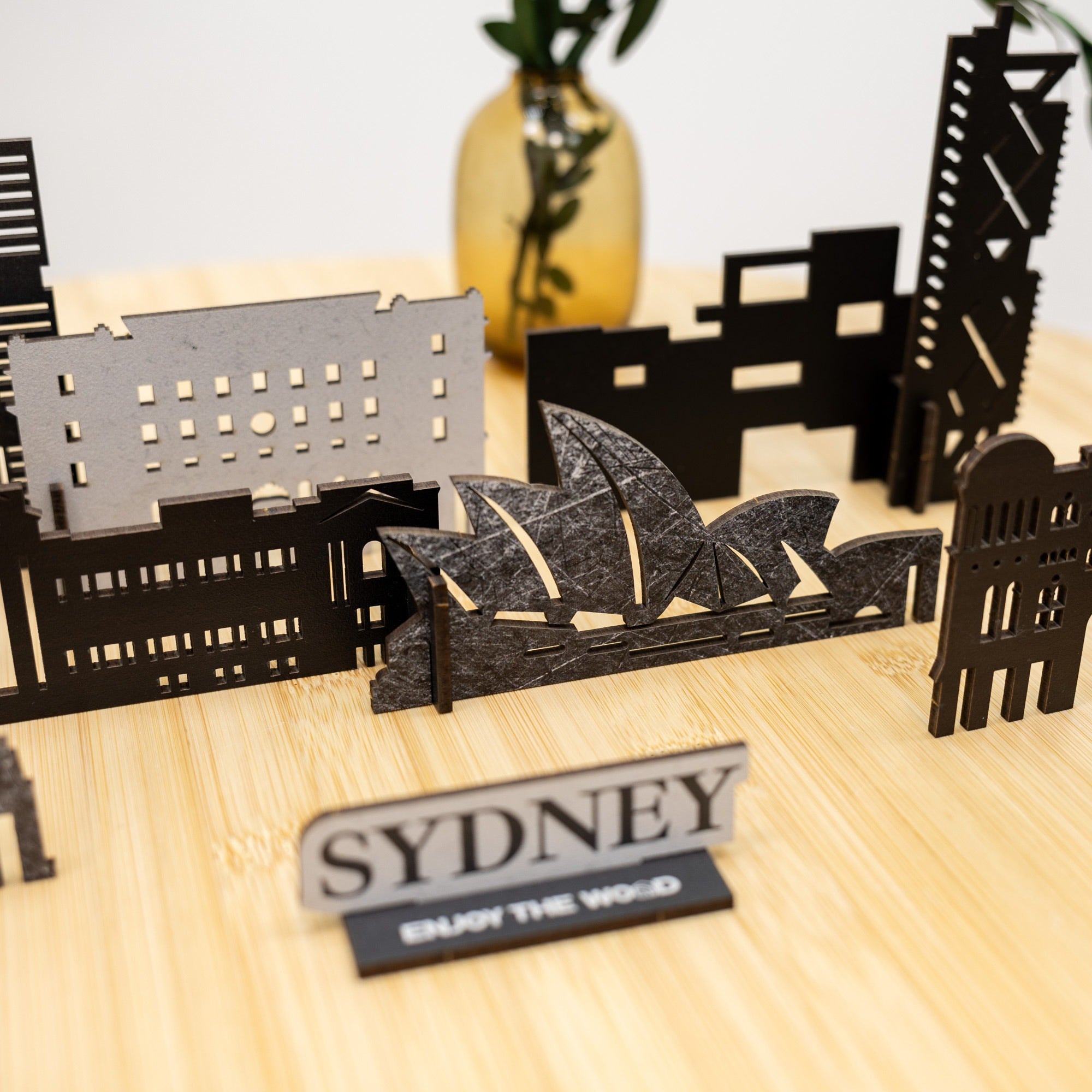Sydney-themed wooden cutouts on a wooden surface with 'Sydney' sign in front.