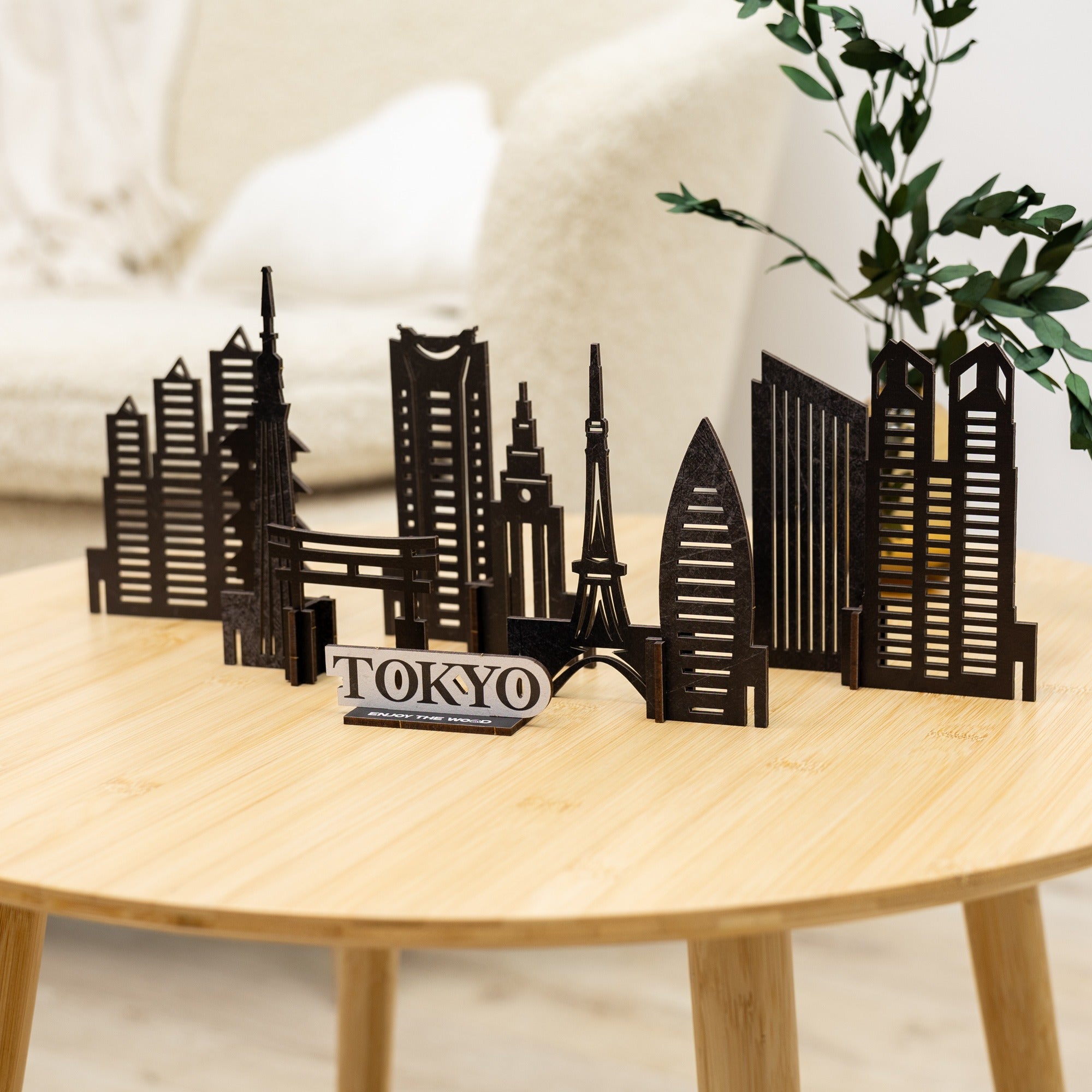 Model of Tokyo skyline on a wooden table with a plant in the background