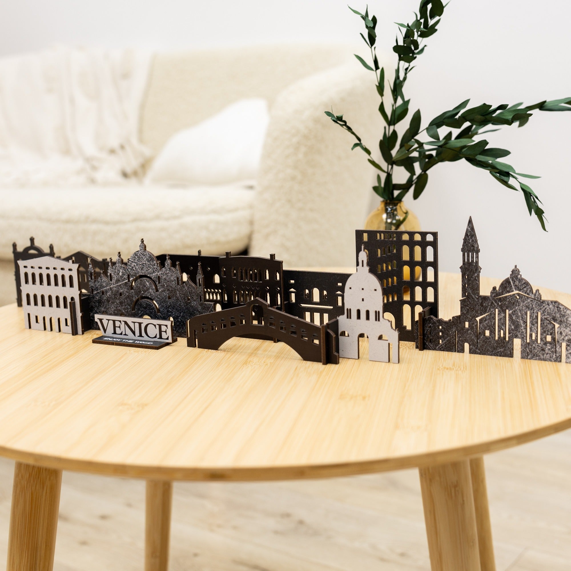 Model of Venice skyline on a wooden table with a plant in the background
