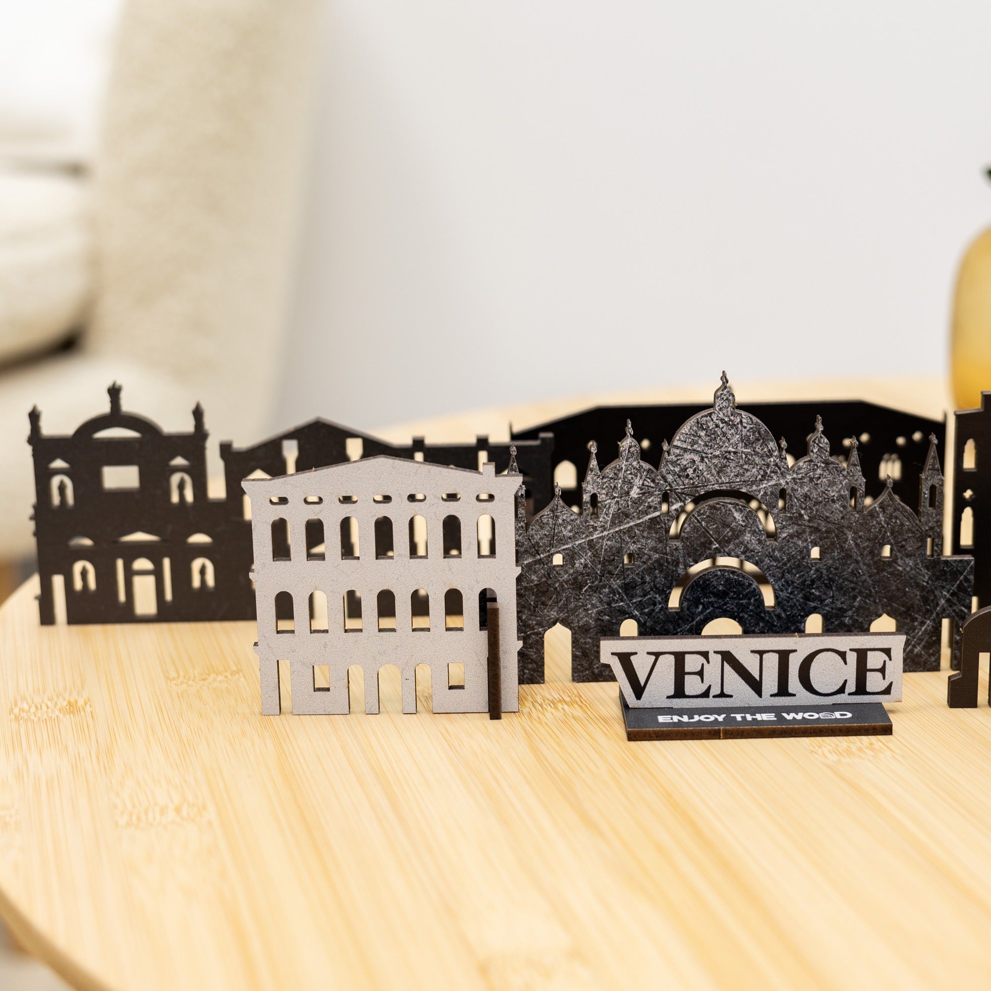 Venice-themed cutout cityscape on a wooden surface with 'VENICE' sign.