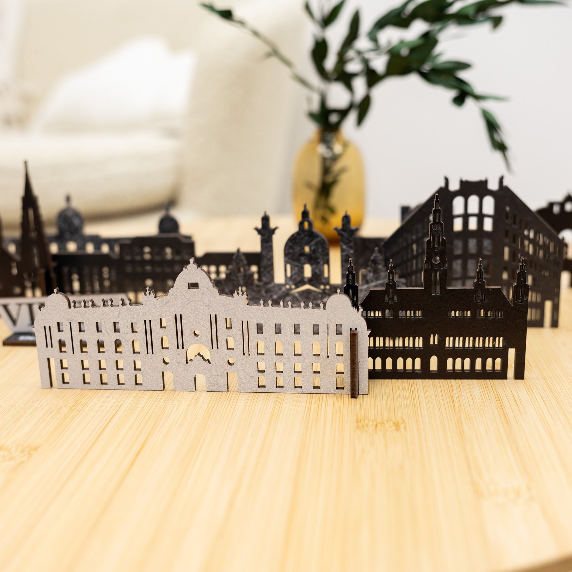 Model of a cityscape with buildings on a wooden surface