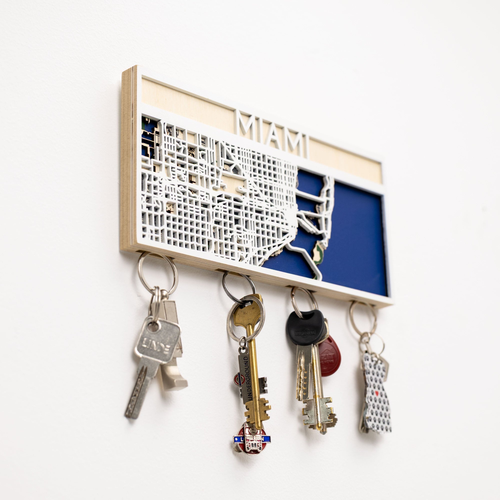Key holder with map design of Miami holding keys on a white background