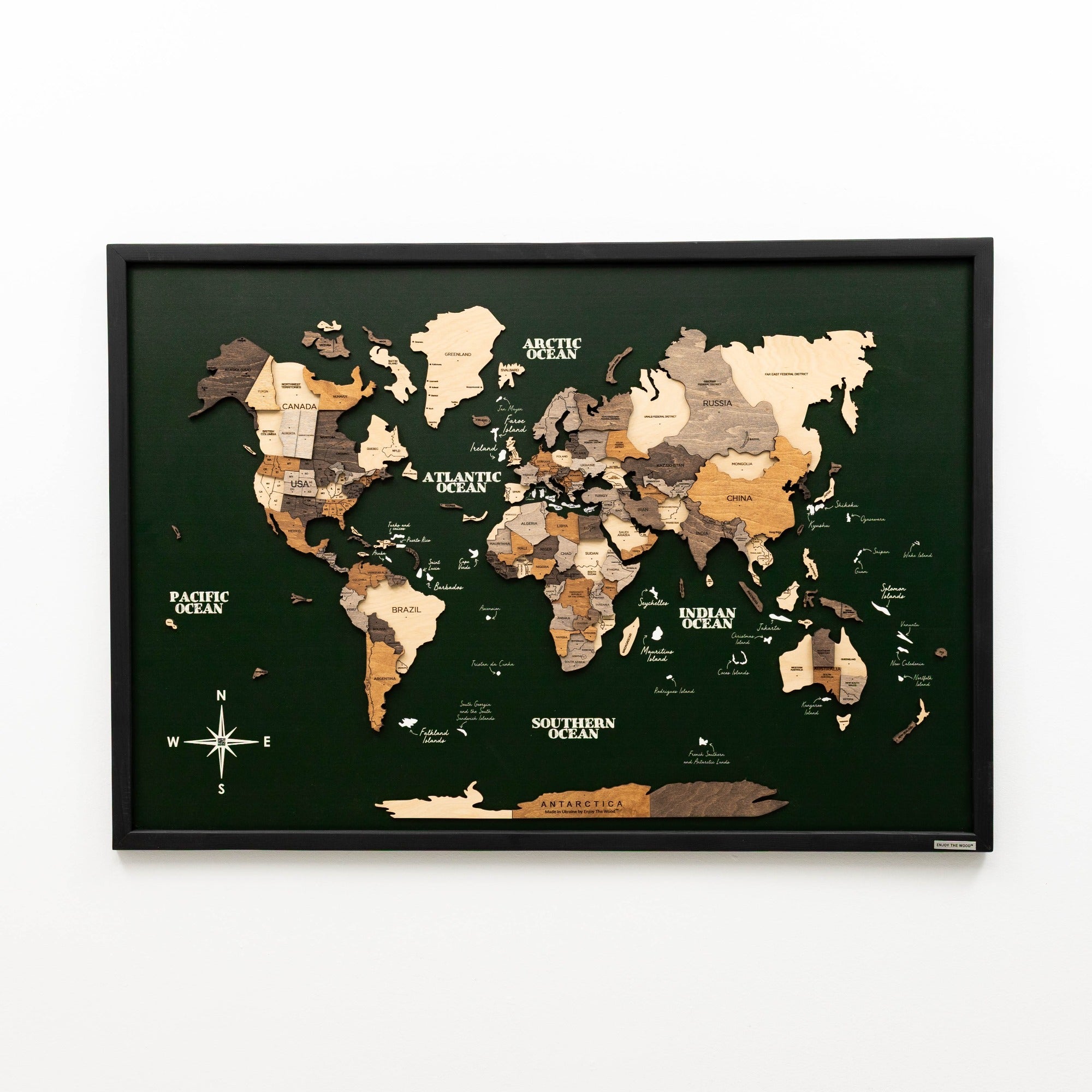 Framed world map with wooden relief on a white background