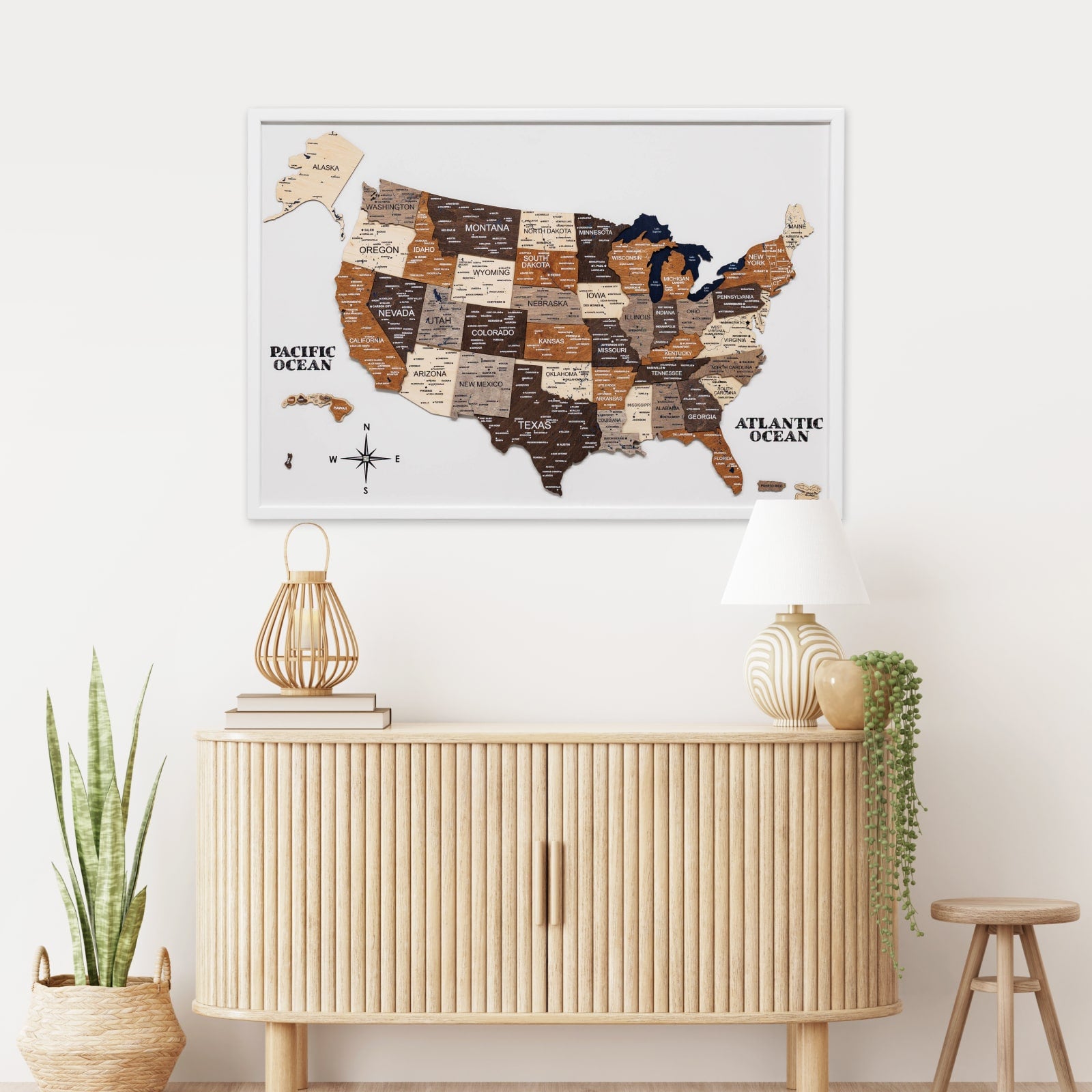Framed map of the United States on a wall above a wooden cabinet with decorative items.