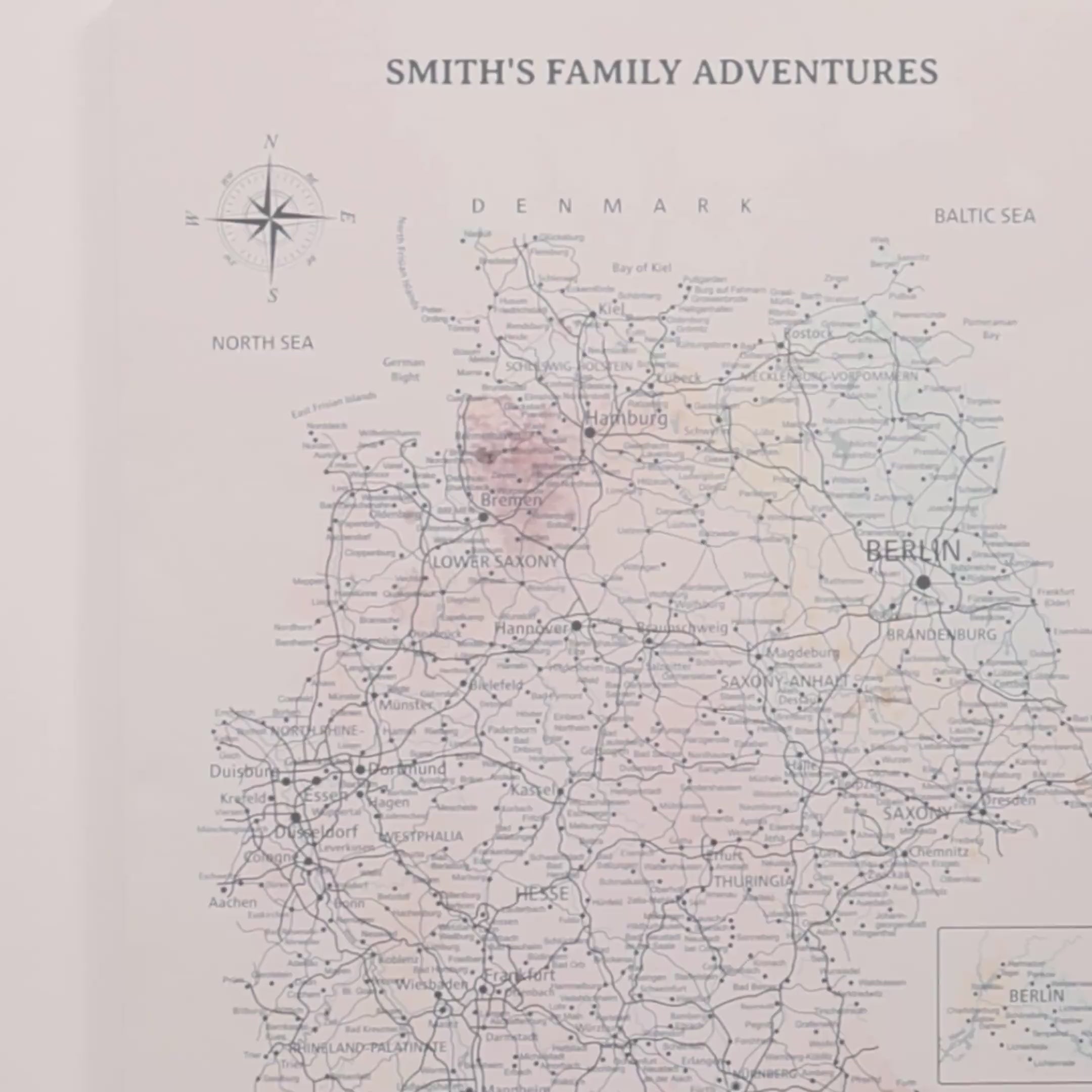 Modern interior with a white dresser, framed map