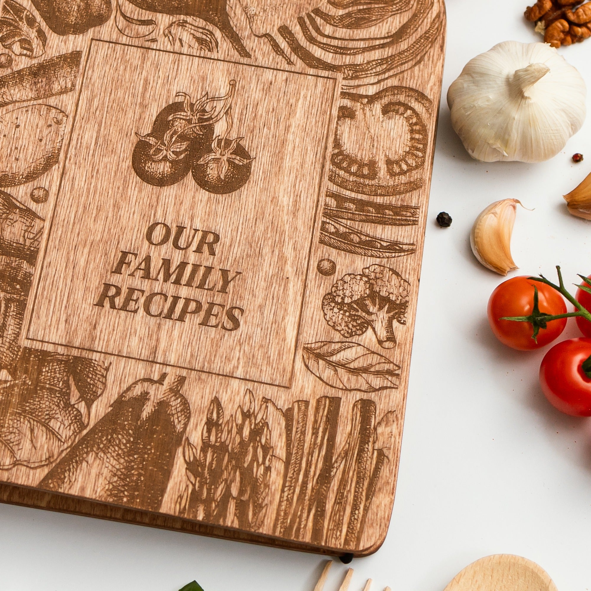 Wooden cookbook titled 'Our Family Recipes' with food illustrations on a white background.