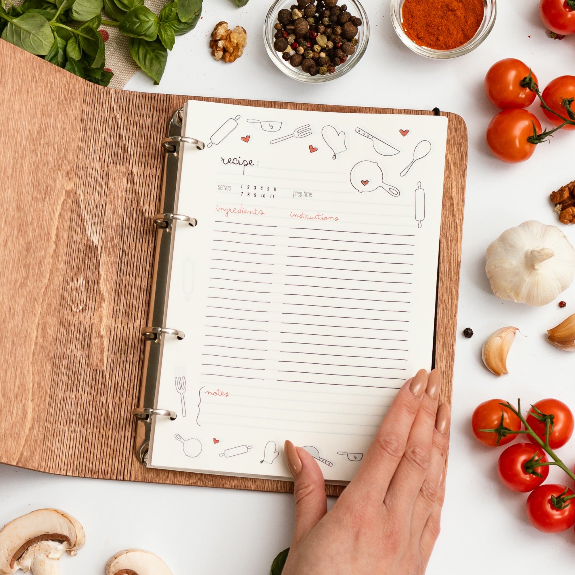 Open recipe book with ingredients on a white surface