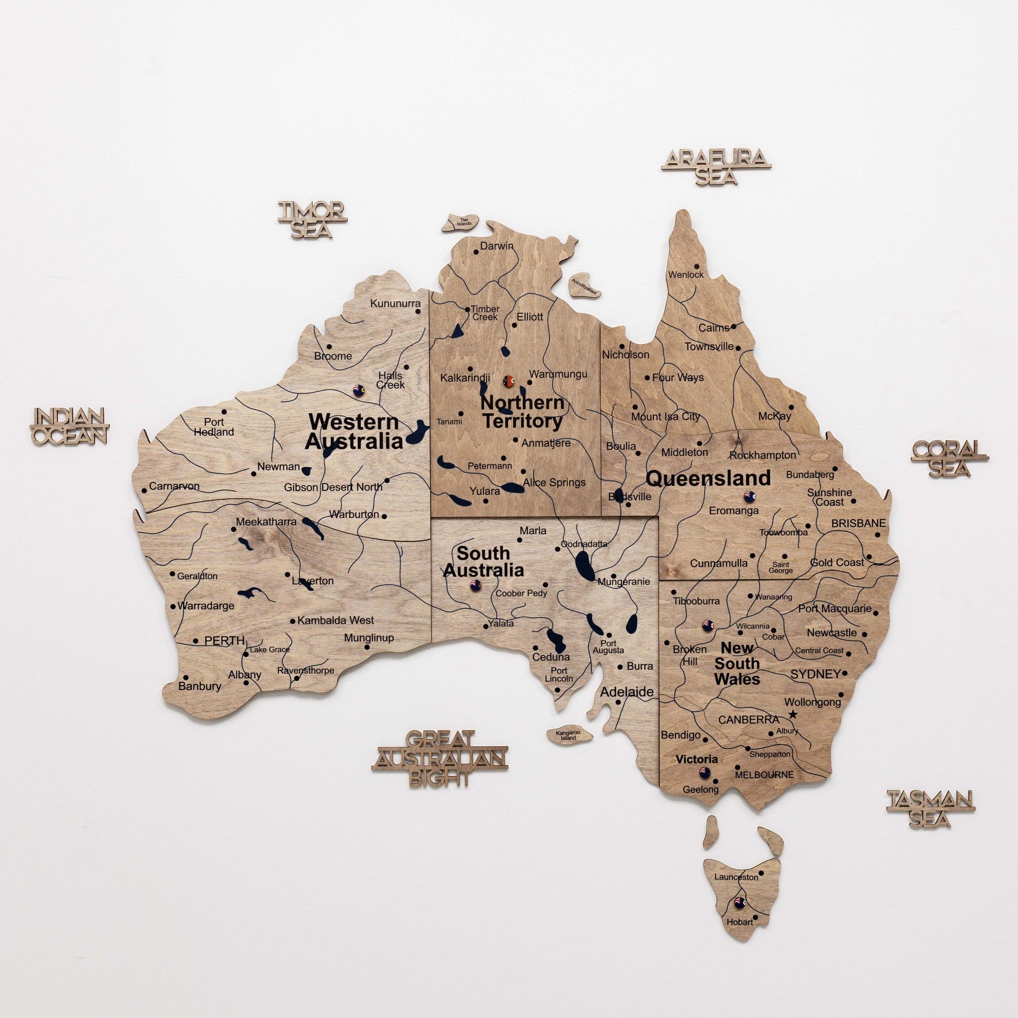 Wooden map of Australia with state names on a white background