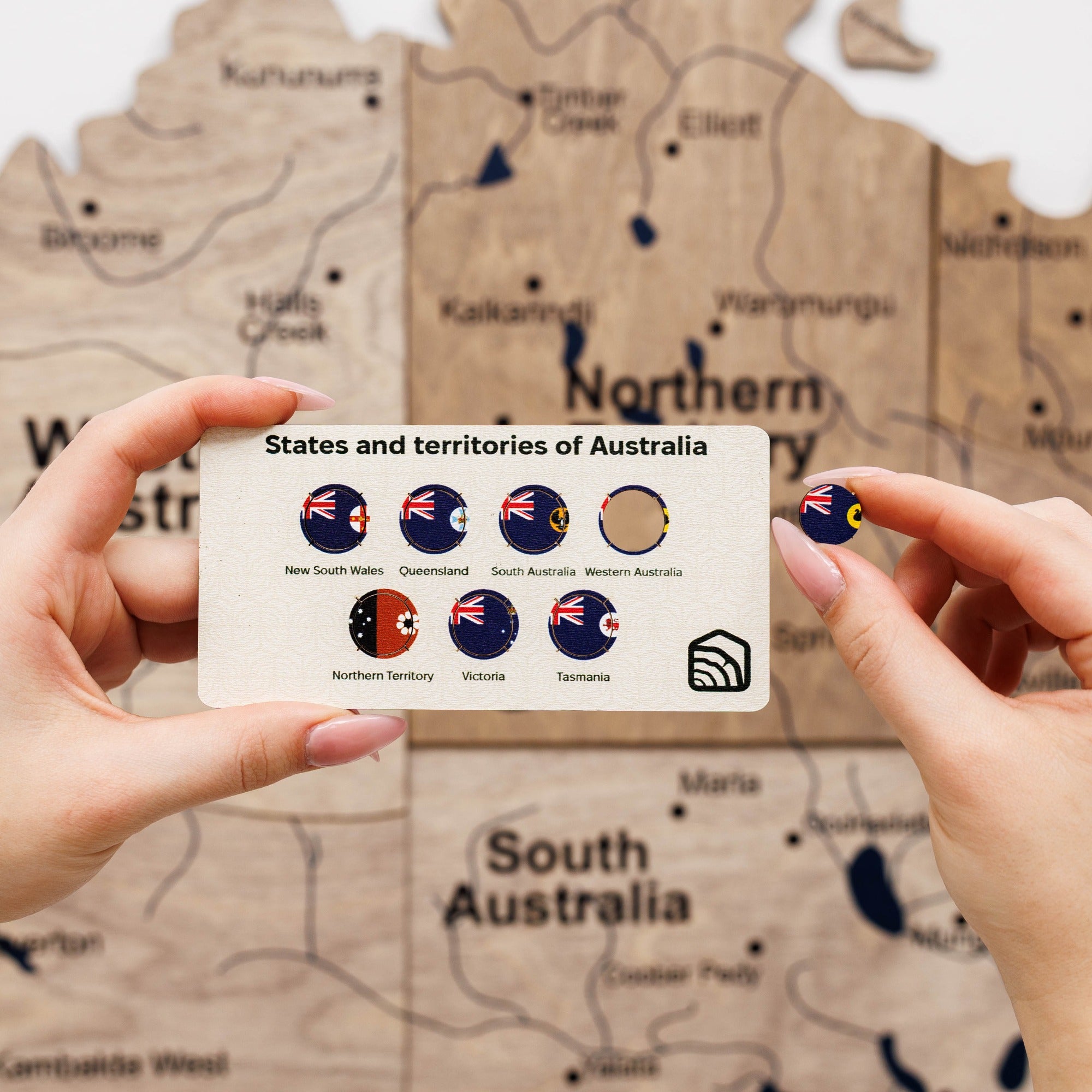 Card with Australian state flags held in front of a map of Australia