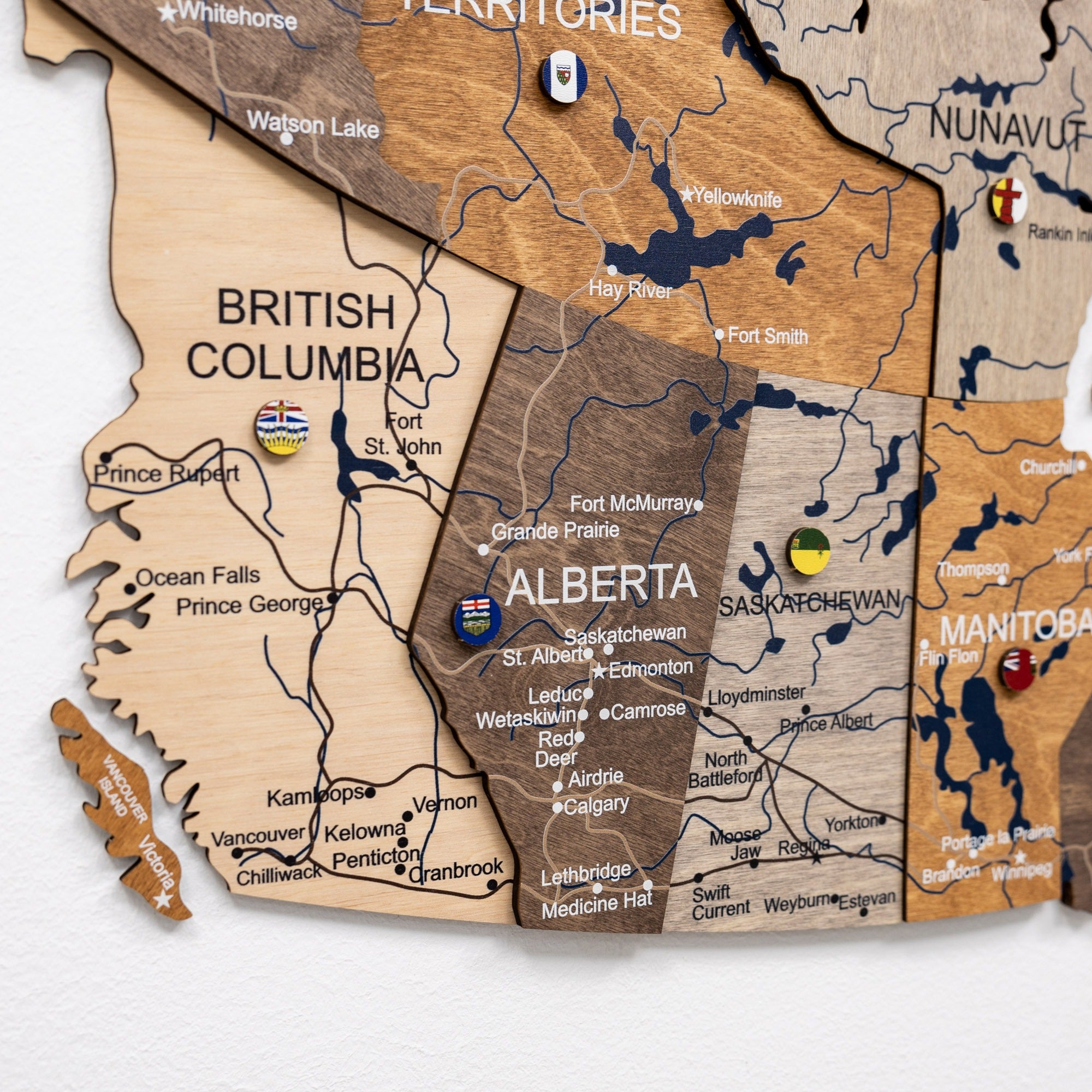 Wooden map of Canada with British Columbia, Alberta, and Saskatchewan highlighted.
