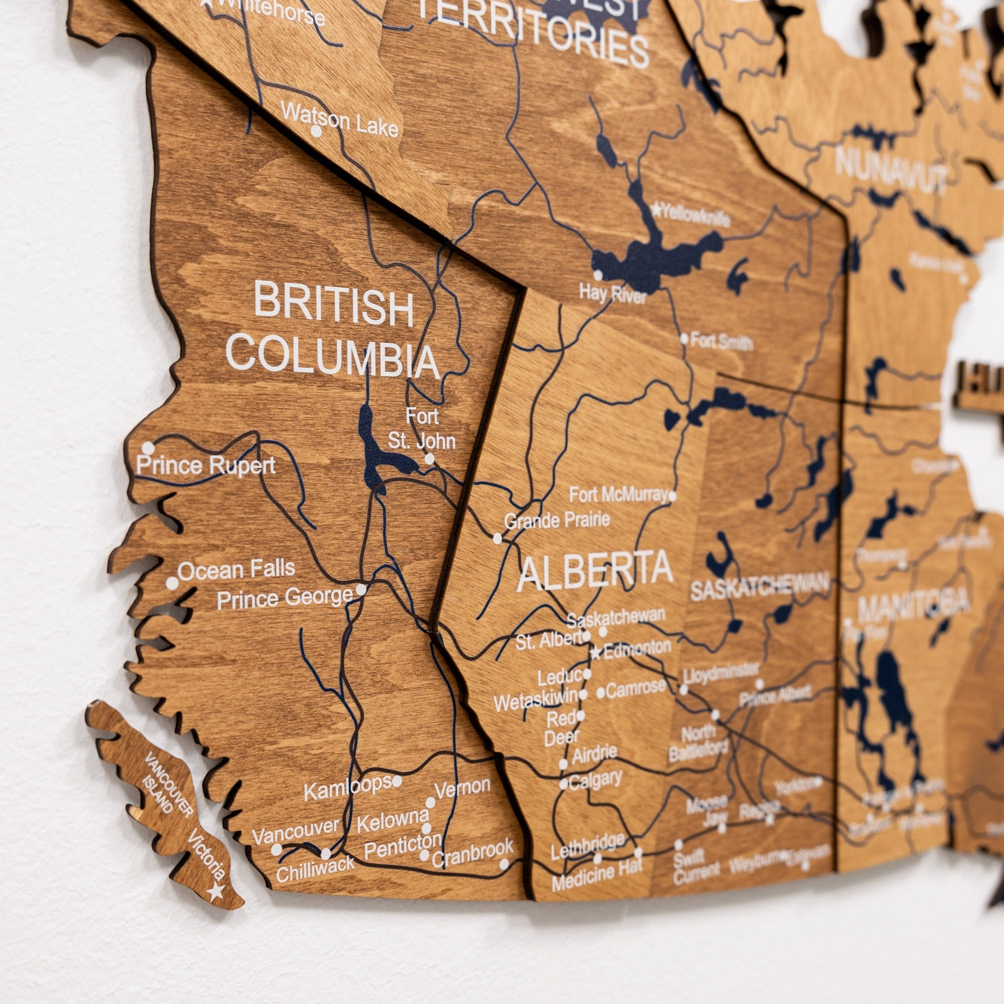 Wooden map of British Columbia and Alberta on a white background