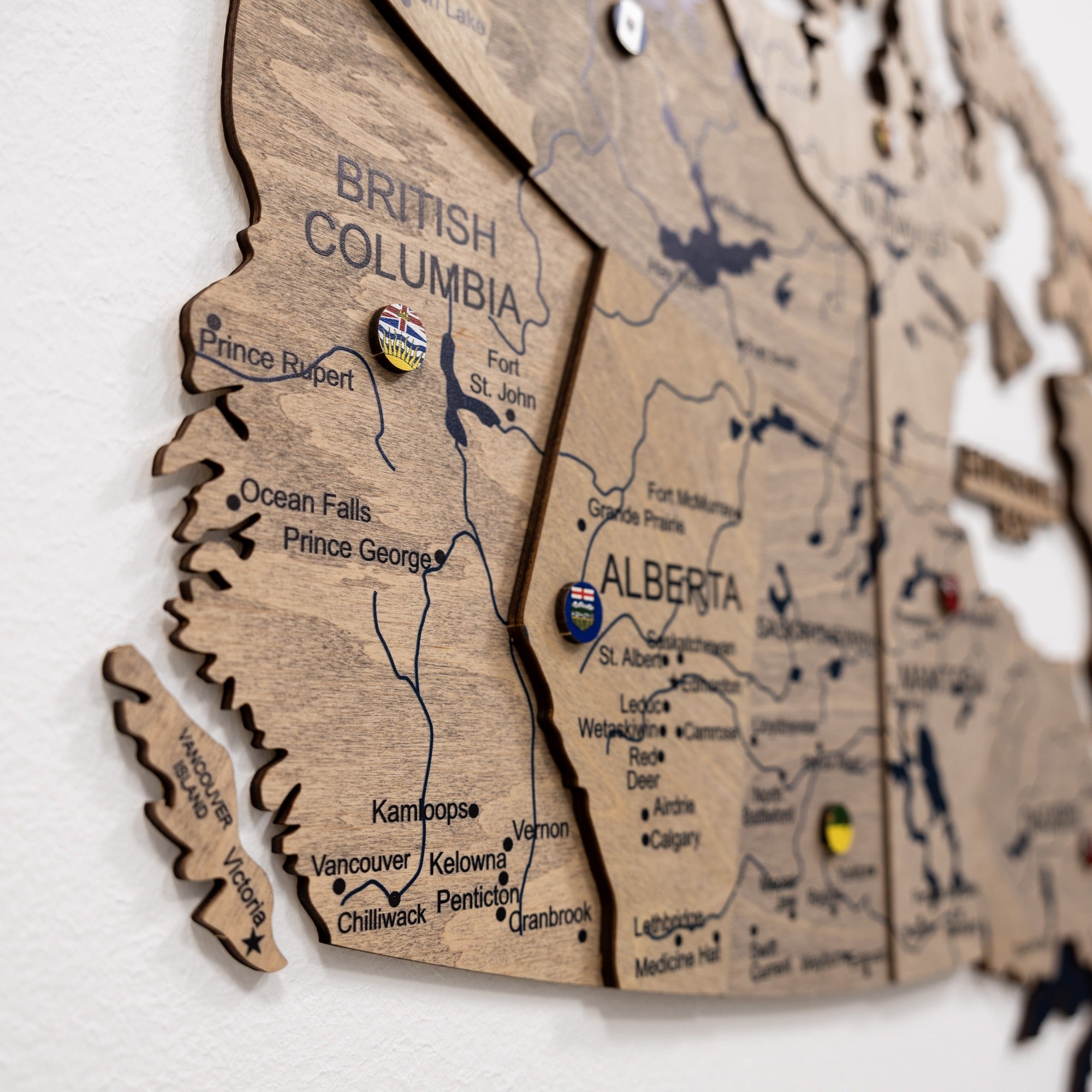 Wooden map of British Columbia with pins marking locations