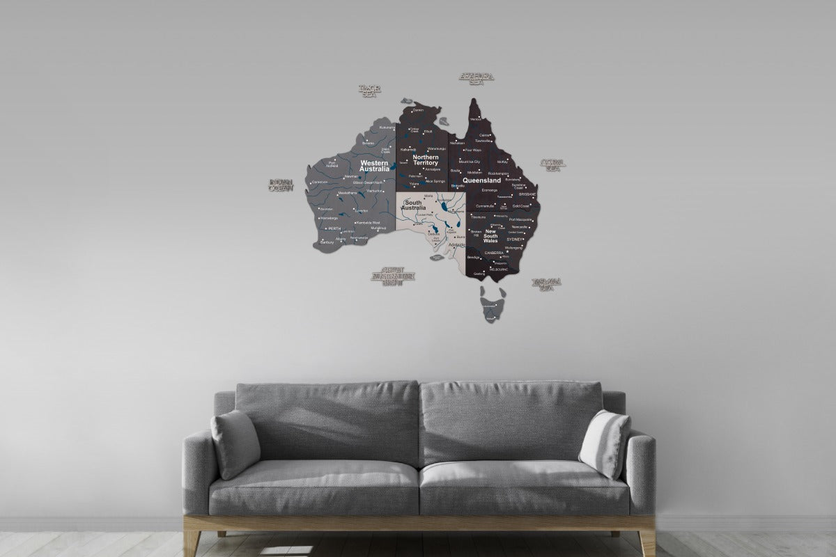 Wall decal of a map of Australia on a gray wall above a gray sofa.
