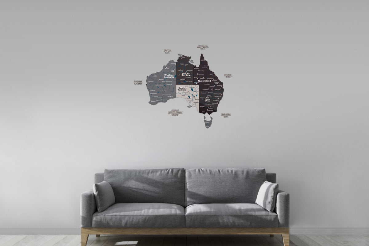 Wall decal of a map of Australia on a gray wall above a gray sofa.
