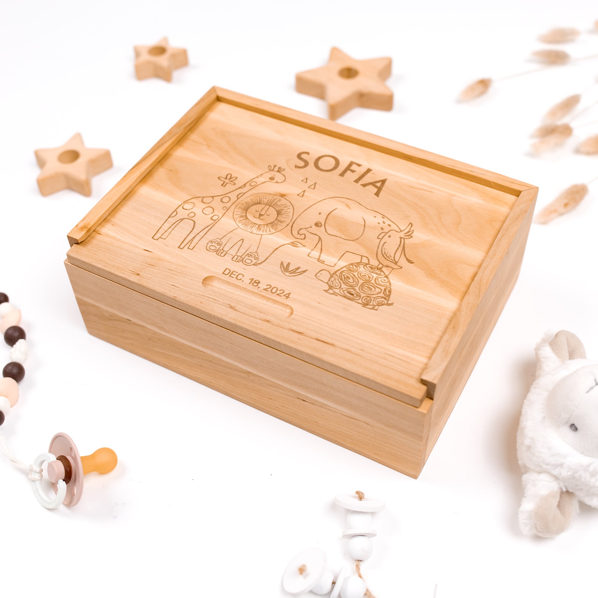 Wooden box engraved with 'SOFIA' and baby-themed illustrations on a white background.
