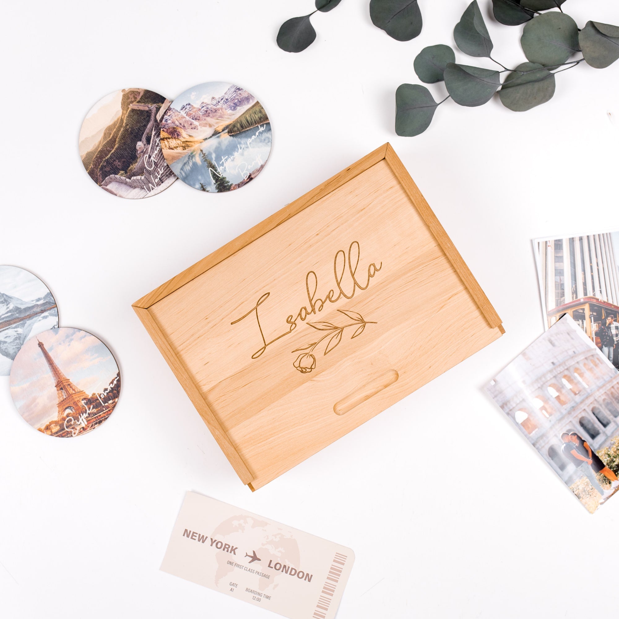 Wooden box with 'Leabella' engraving, travel-themed coasters, and cards on a white background.