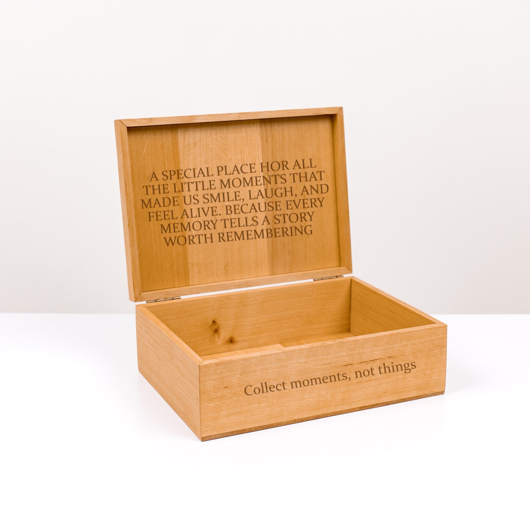 Wooden memory box with engraved text on a white background