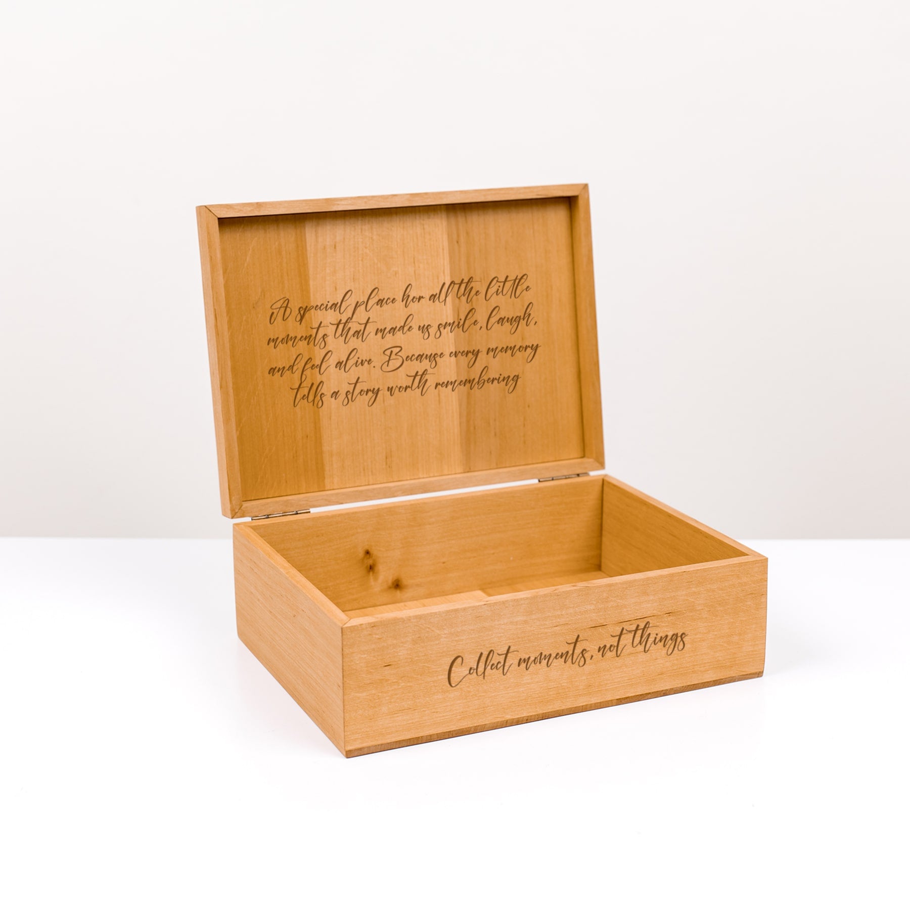 Wooden memory box with engraved text on a white background